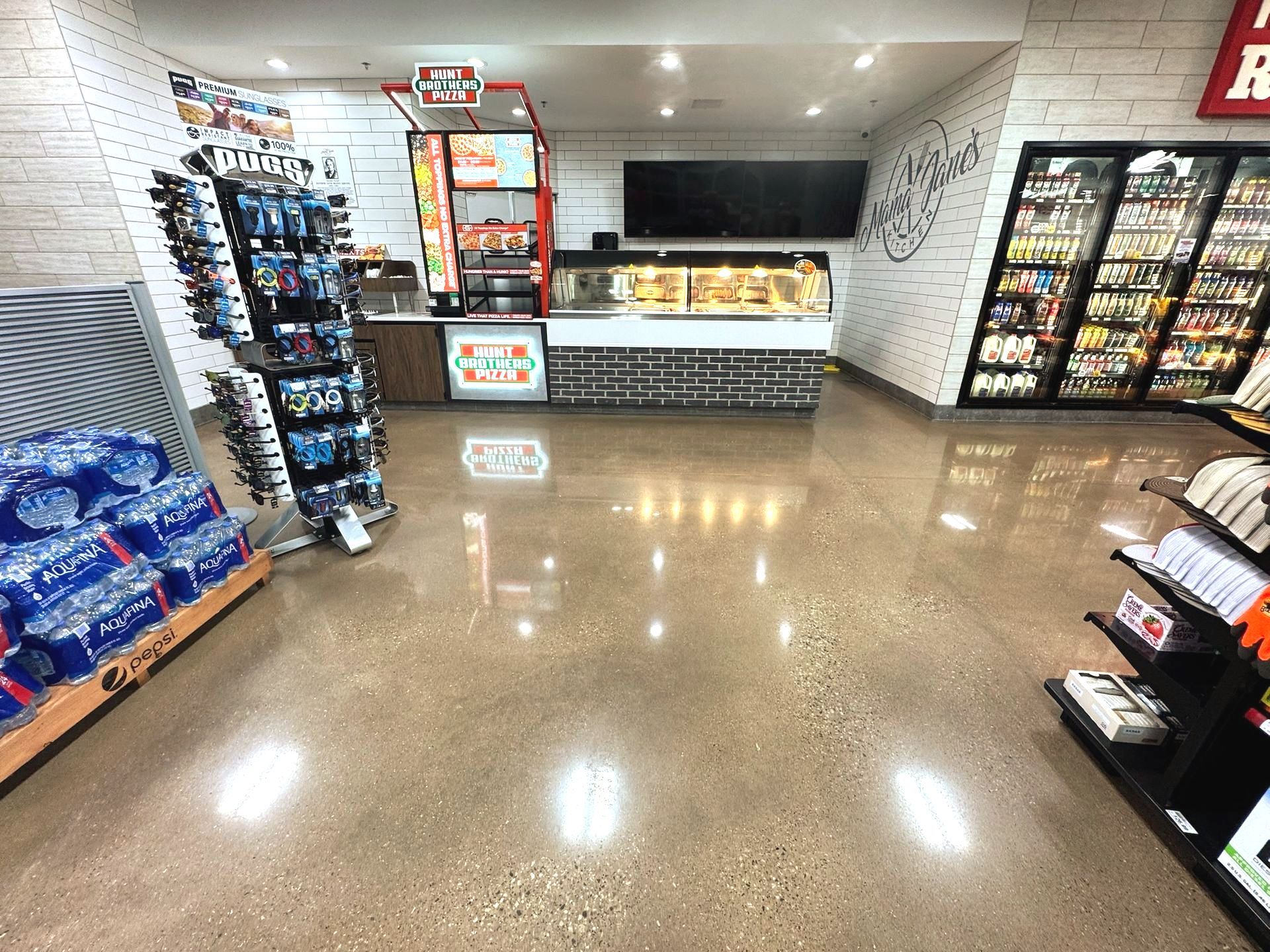 The inside of a grocery store with lots of shelves and a counter.