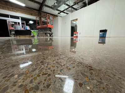 A store with a shiny floor and a sign that says fresh brewed