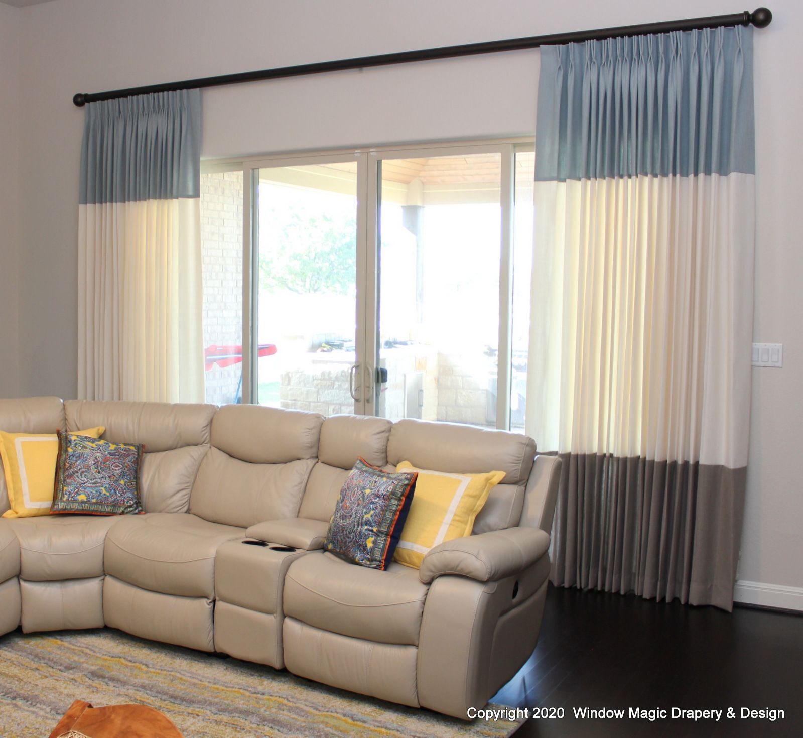 A living room with a couch , curtains and a dog.