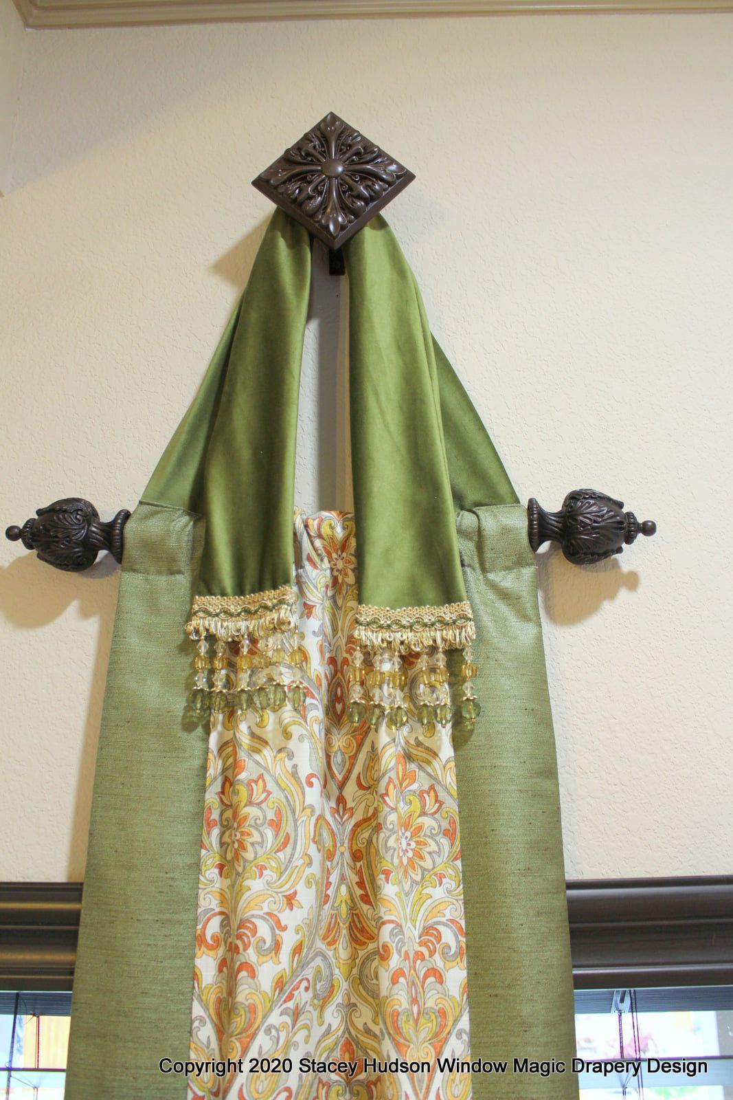 A pair of curtains hanging from a curtain rod on a window.