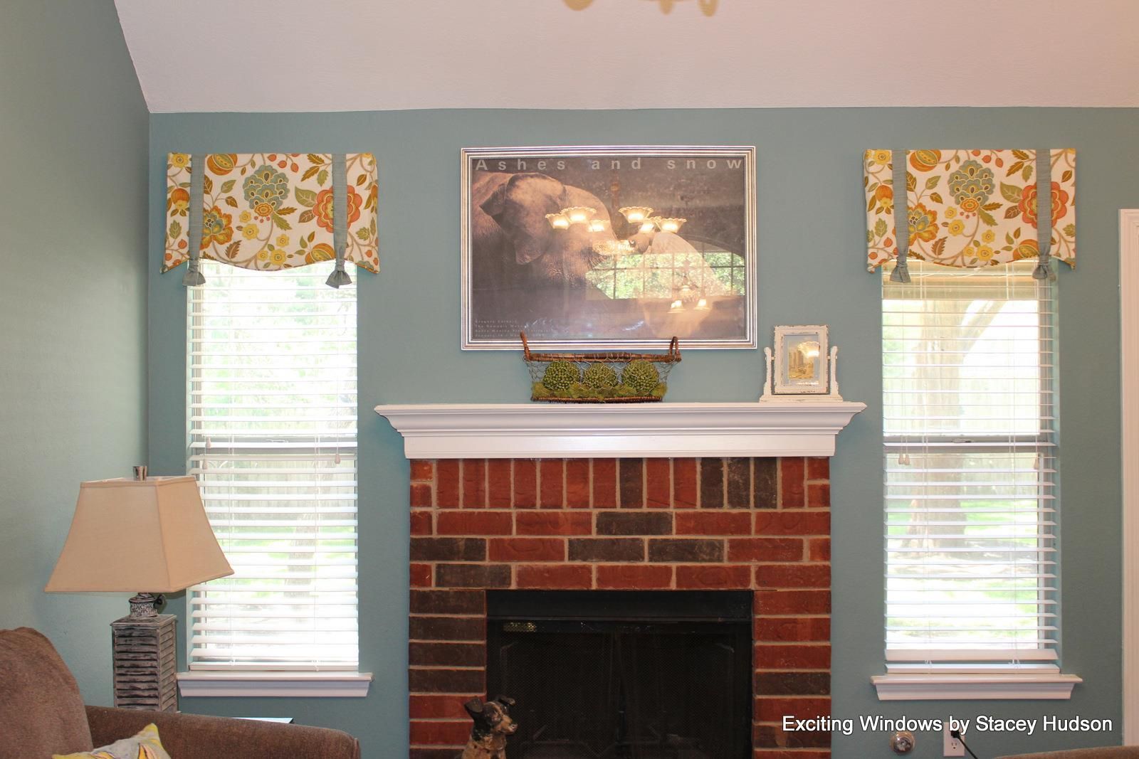 A living room with a brick fireplace and a lamp