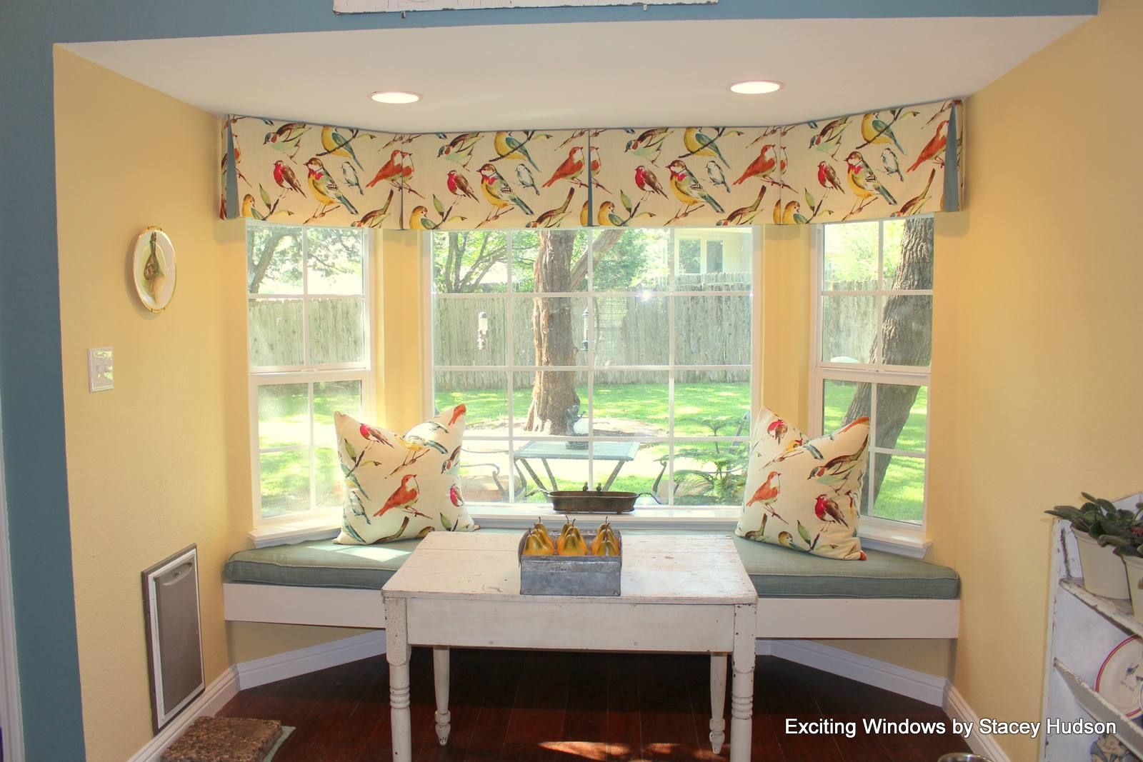 A living room with a window seat and a table