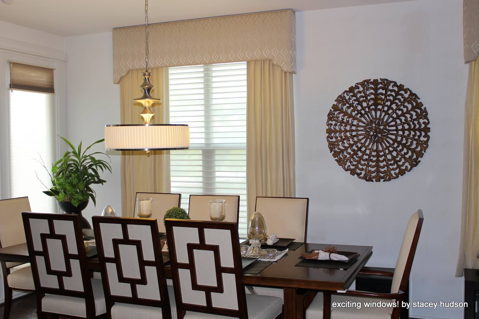 A dining room with a table and chairs and a chandelier