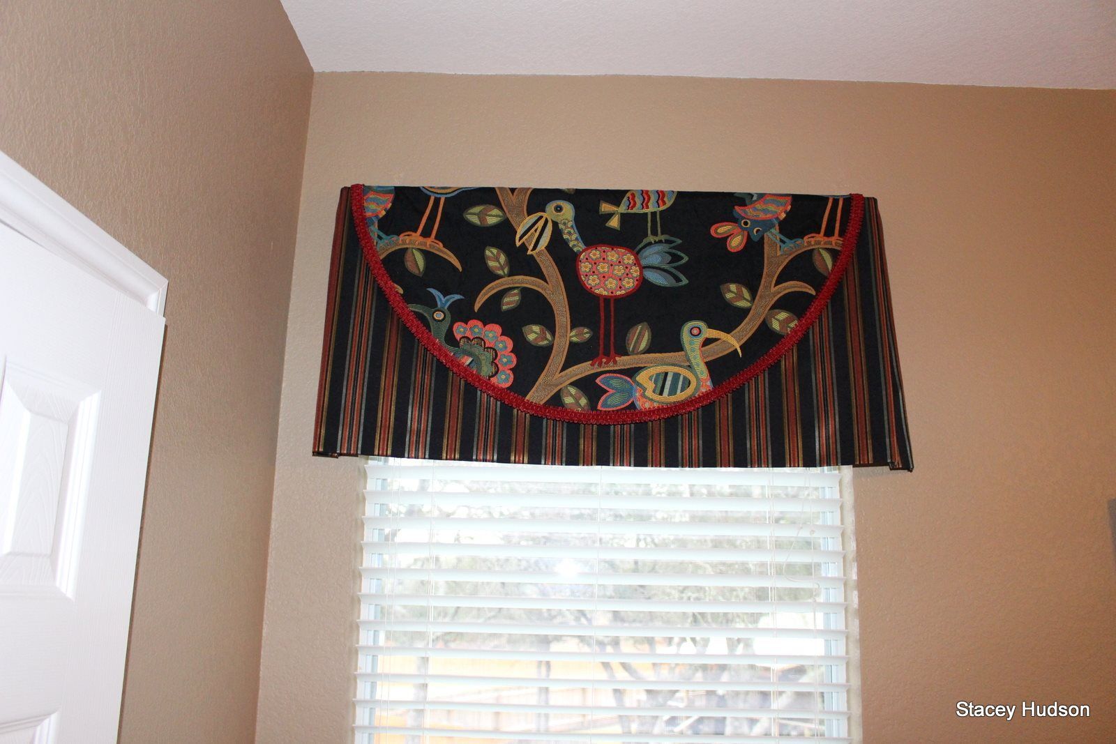 A window with blinds and a curtain on it