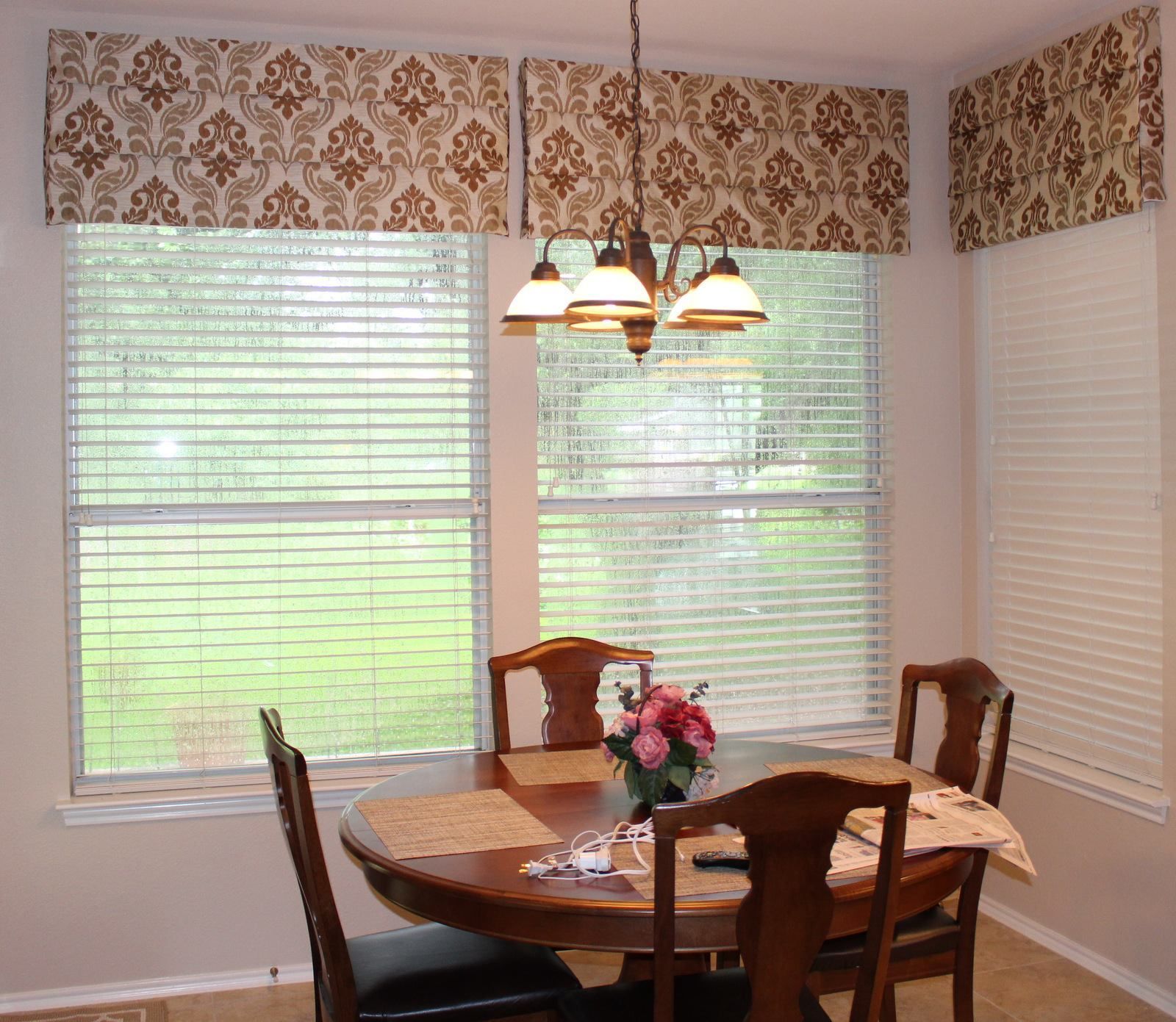 A dining room with a table and chairs and a chandelier