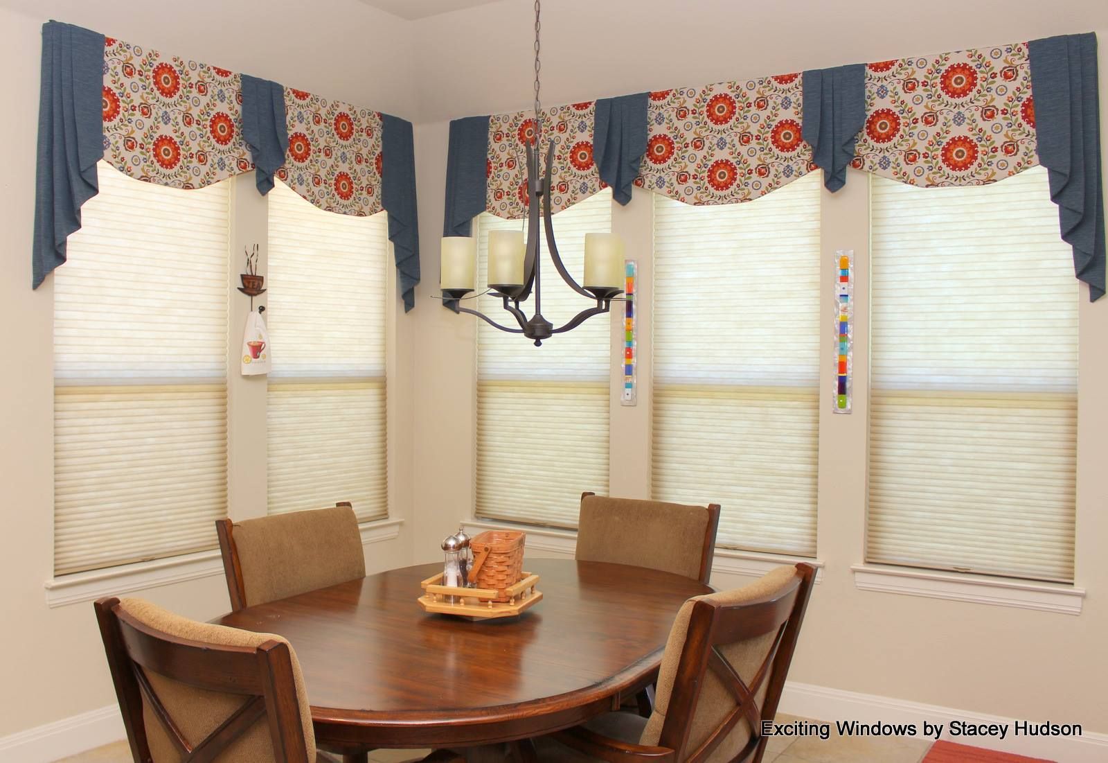 A dining room with a table and chairs and a chandelier.