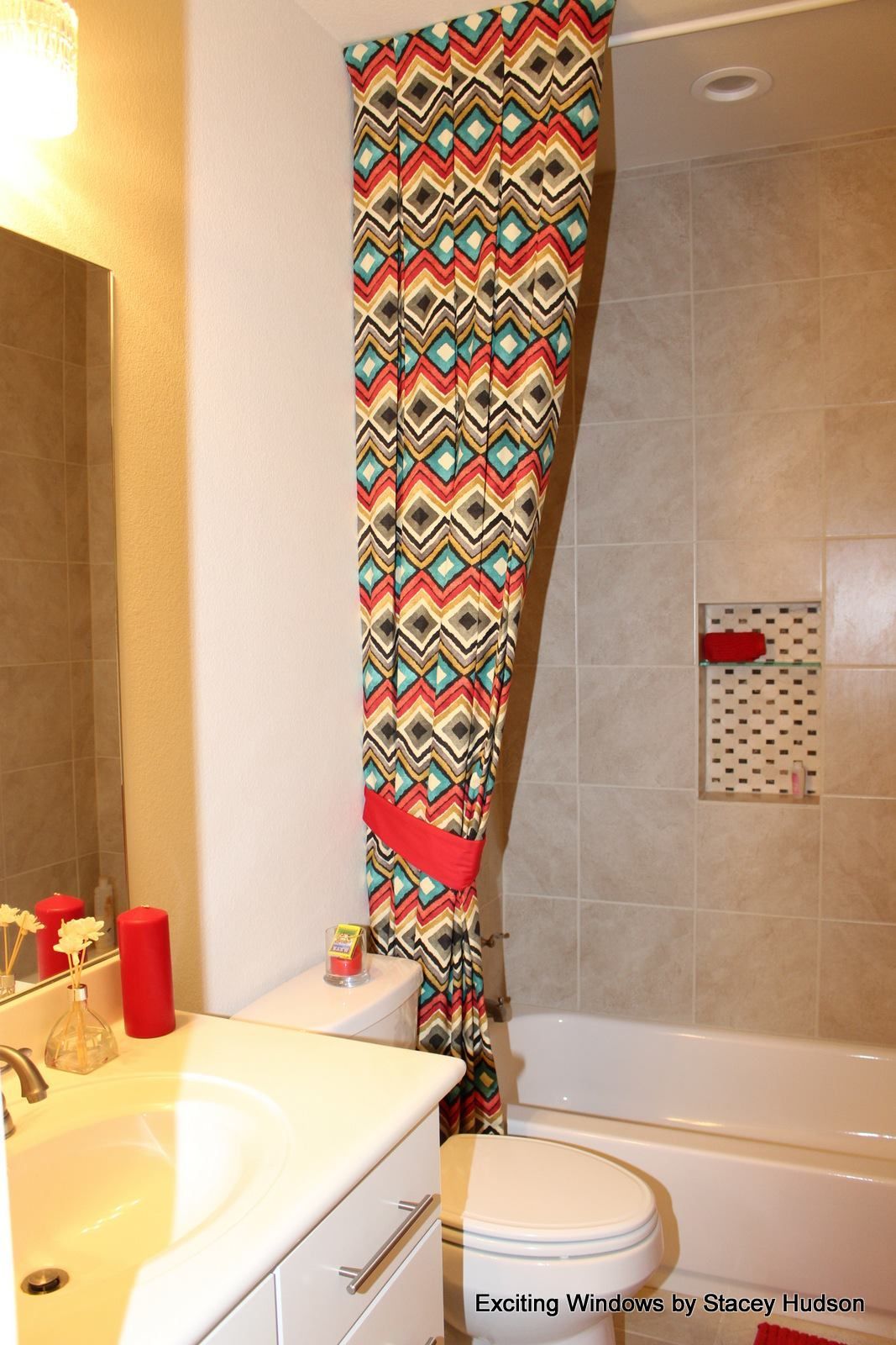 A bathroom with a colorful shower curtain and a bathtub