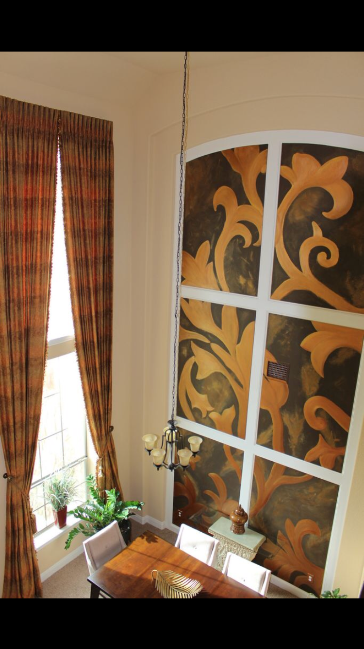 A dining room with a table and chairs and a window
