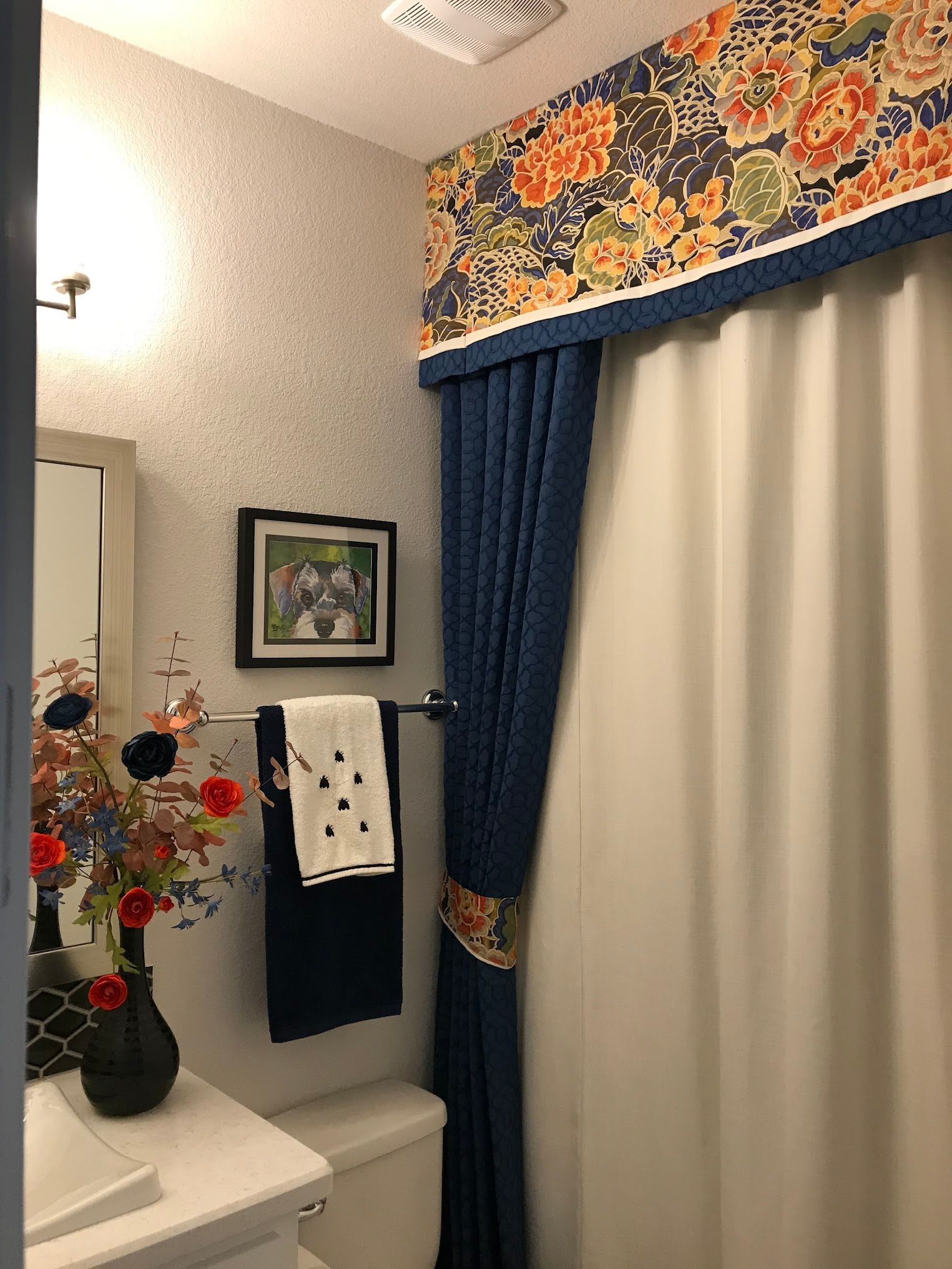A bathroom with a sink , toilet , and shower curtain.