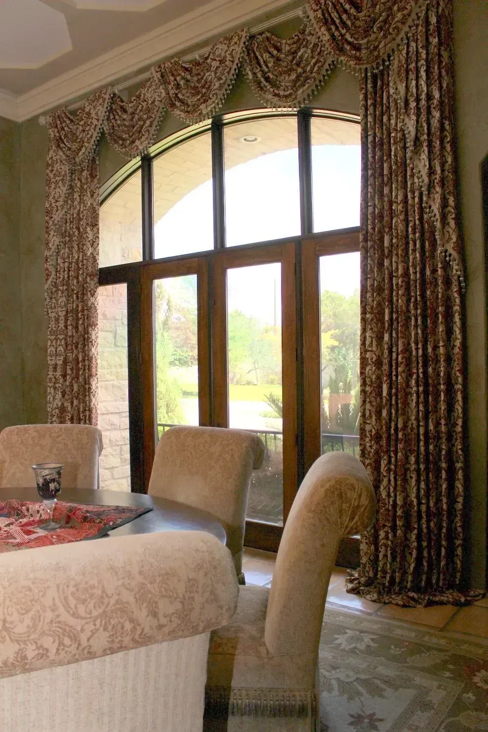 A living room with a couch and chairs and a large window