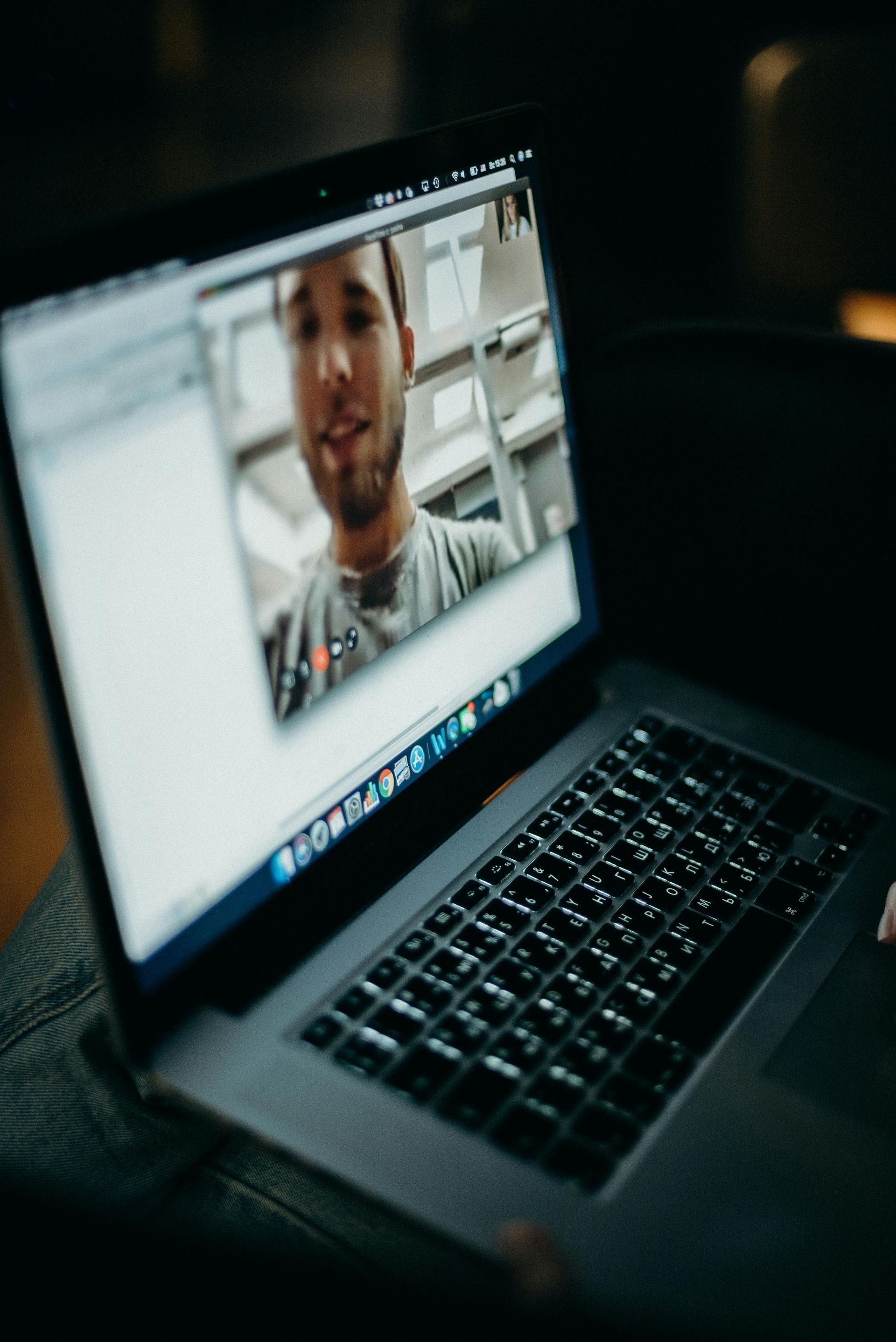 A laptop with a picture of a man on the screen