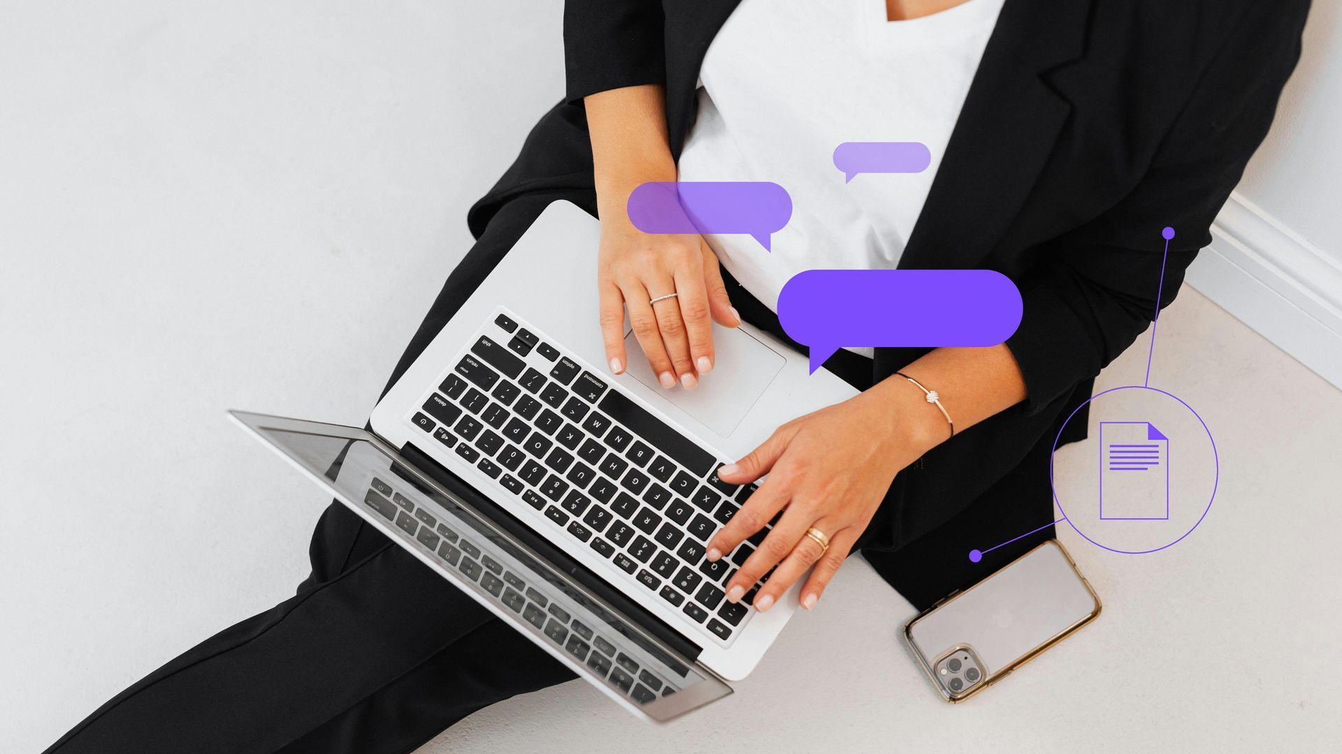 A woman is sitting on the floor using a laptop computer.