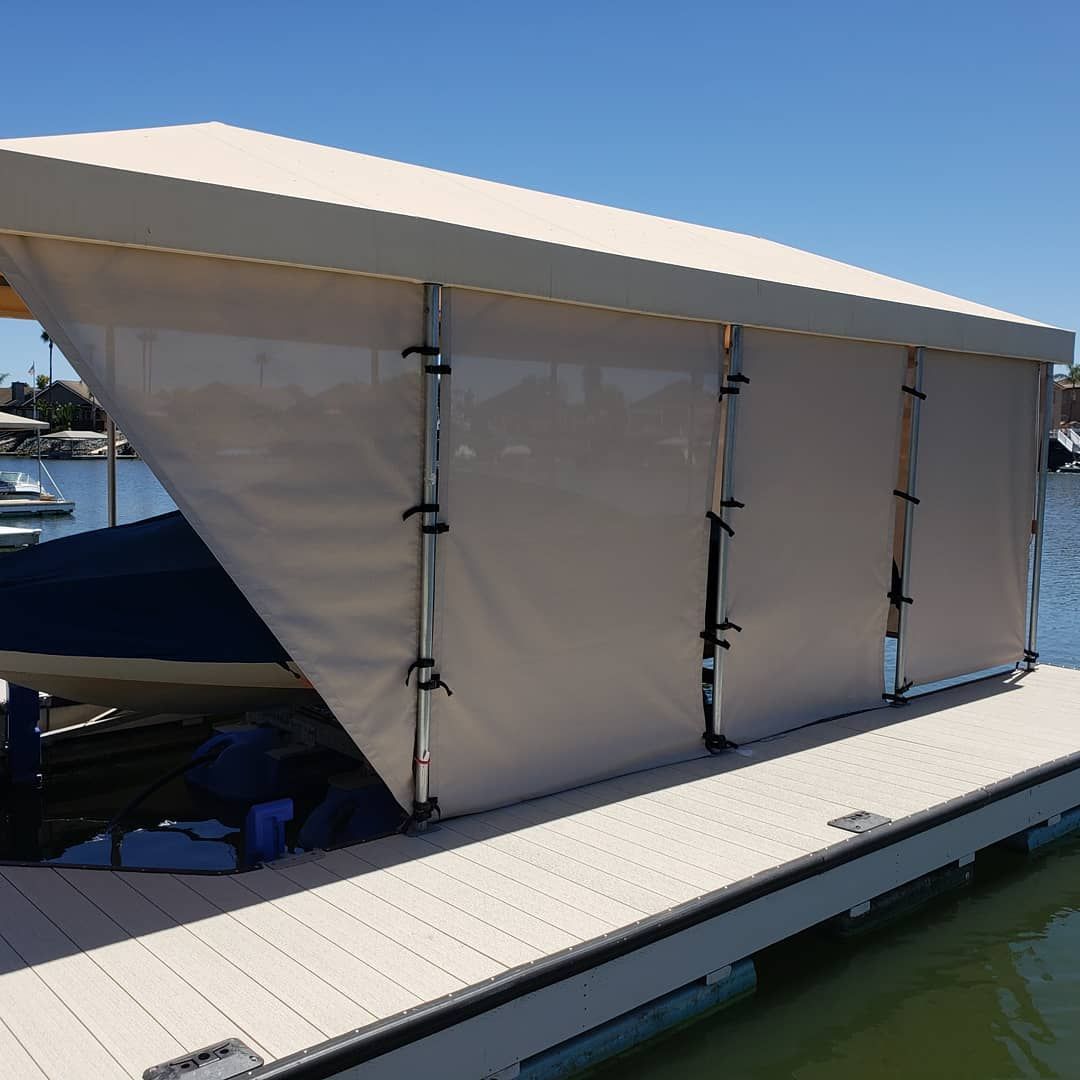 A boat is sitting on a dock with a canopy over it