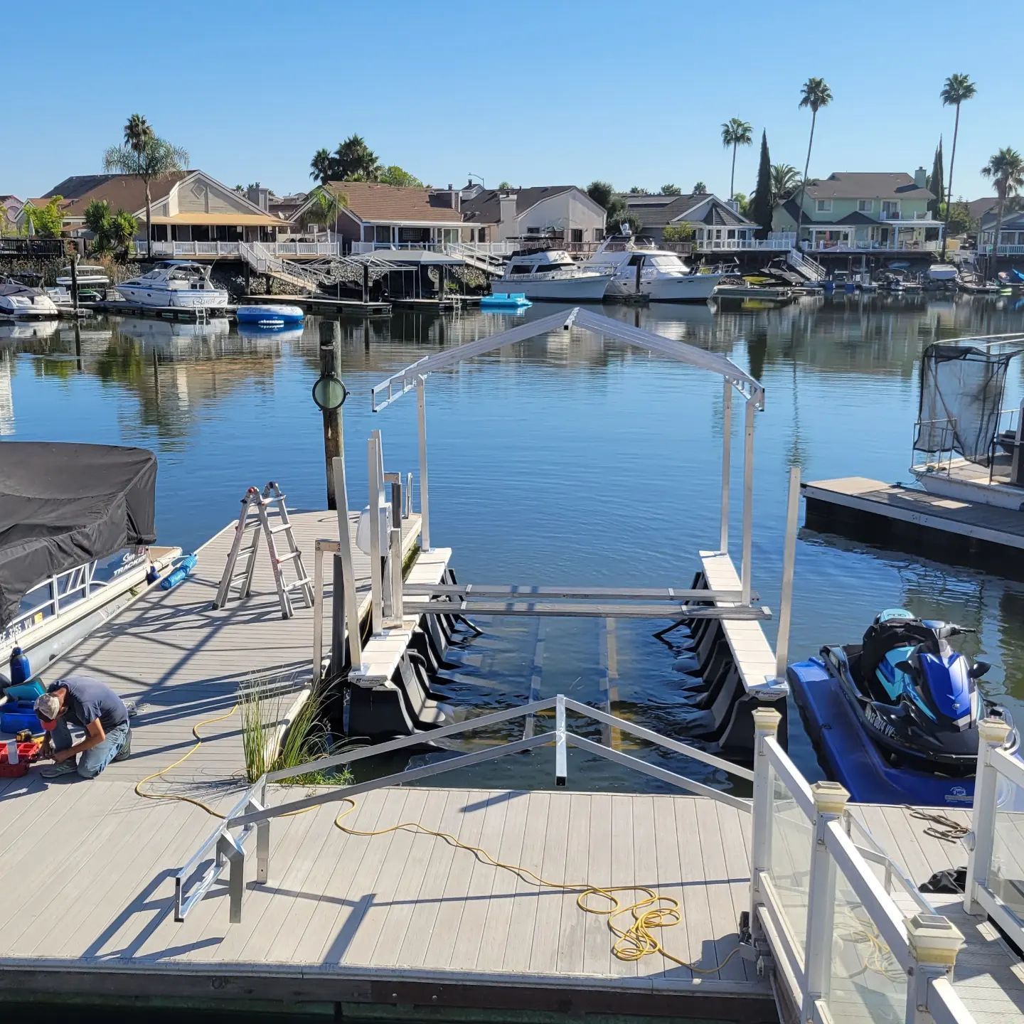 A man is working on a jet ski on a dock