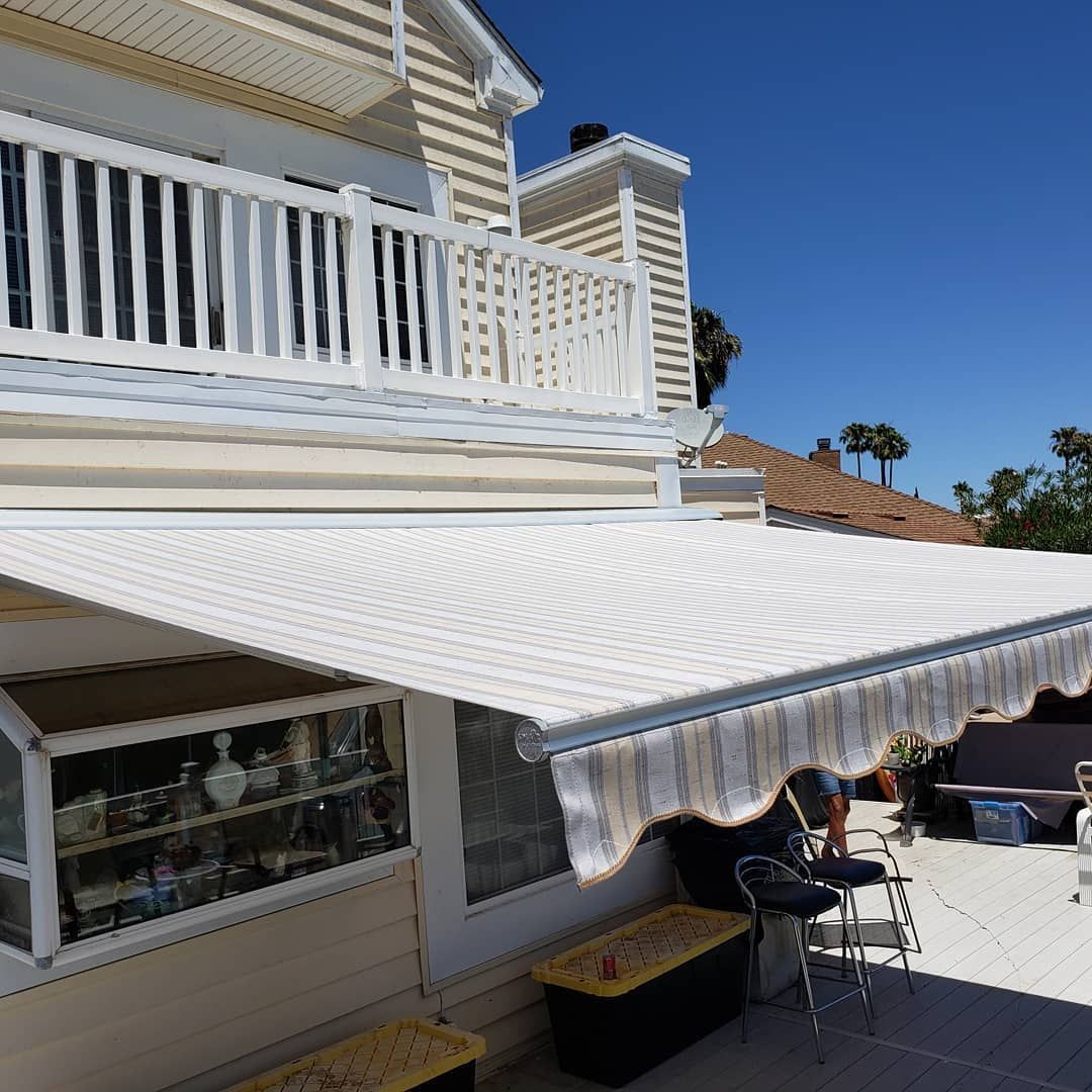 A white awning is on the side of a house