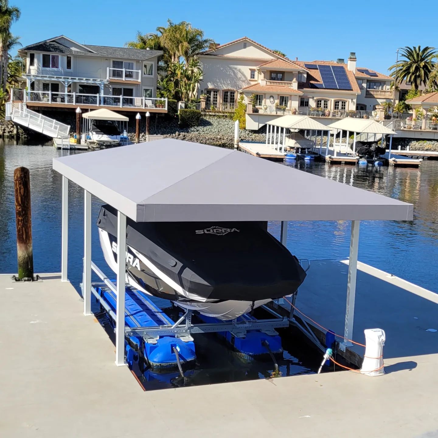 A boat is sitting under a canopy on a dock