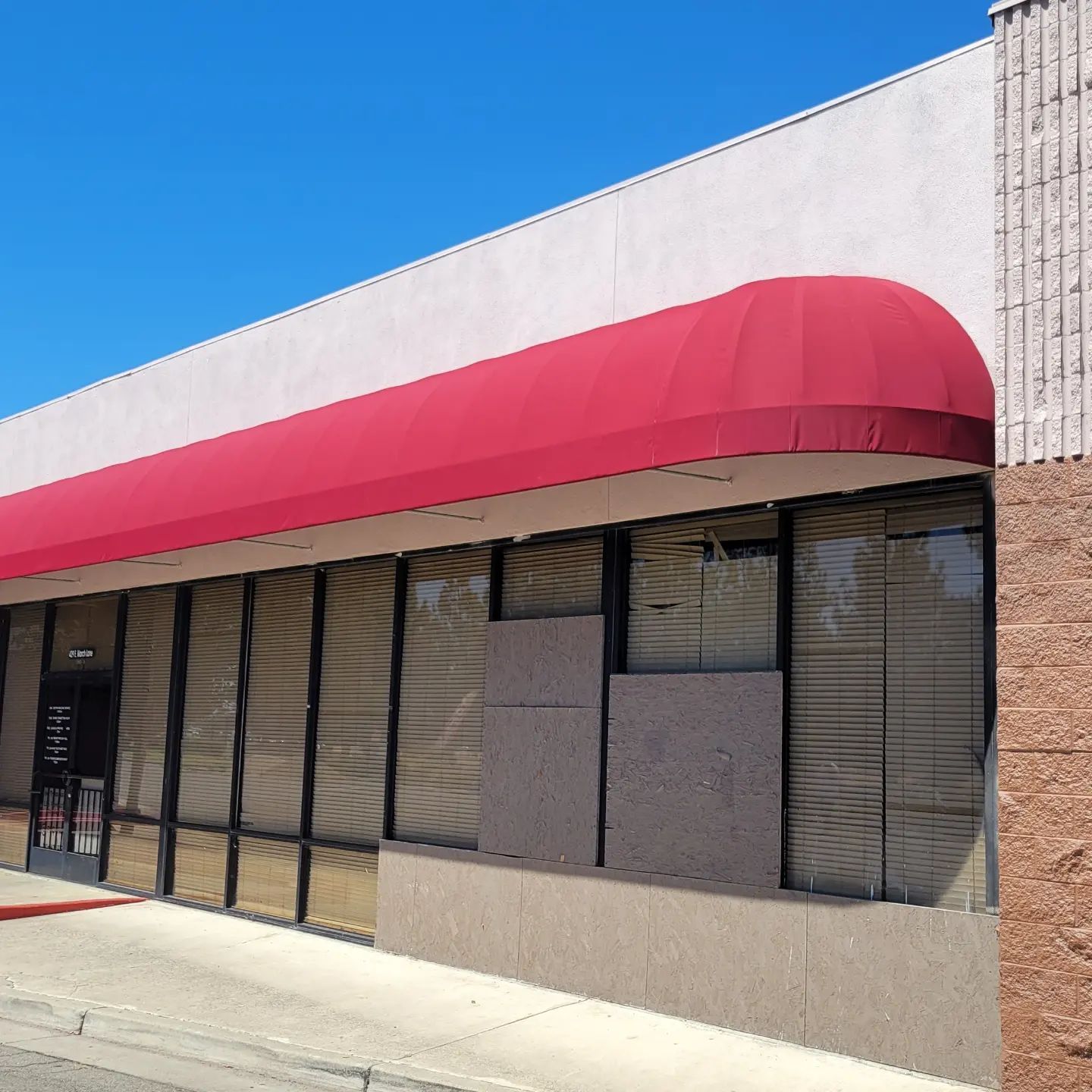 A building with a red awning on top of it