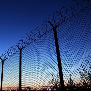 Barbed Wire Fence at Dusk — Modesto, CA — Sam Farias Fencing, Inc