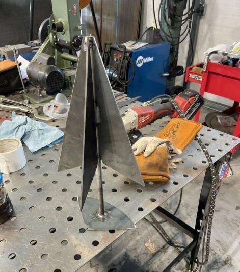 A welding table with a miller welding machine in the background