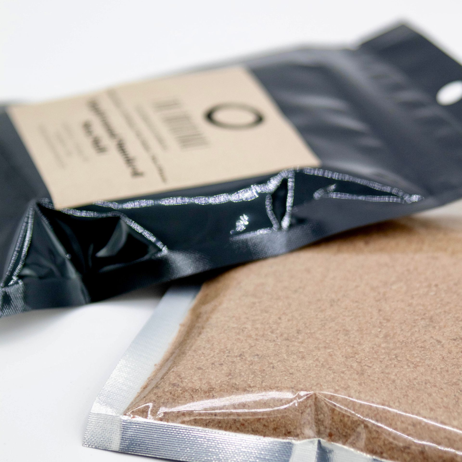 A close up of a bag of sand that says o on it