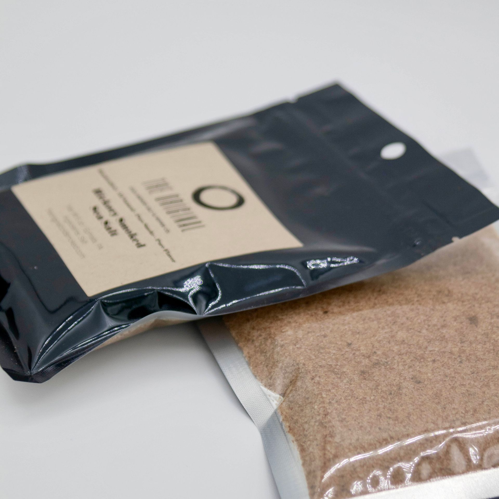 A bag of brown powder with the letter o on it