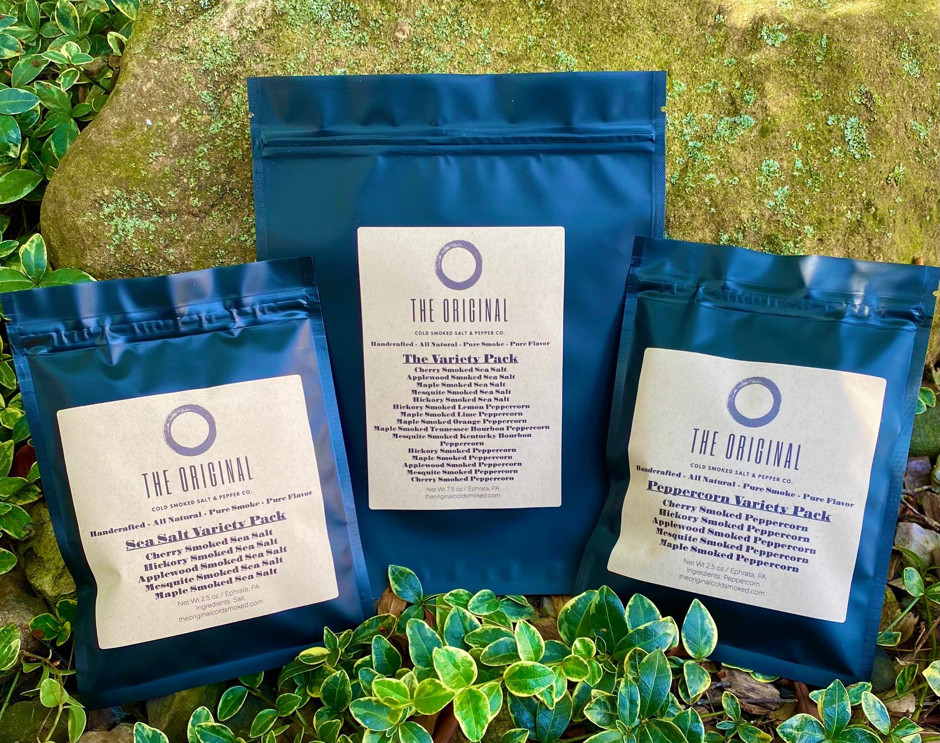 Three bags of tea are sitting next to each other on a rock.