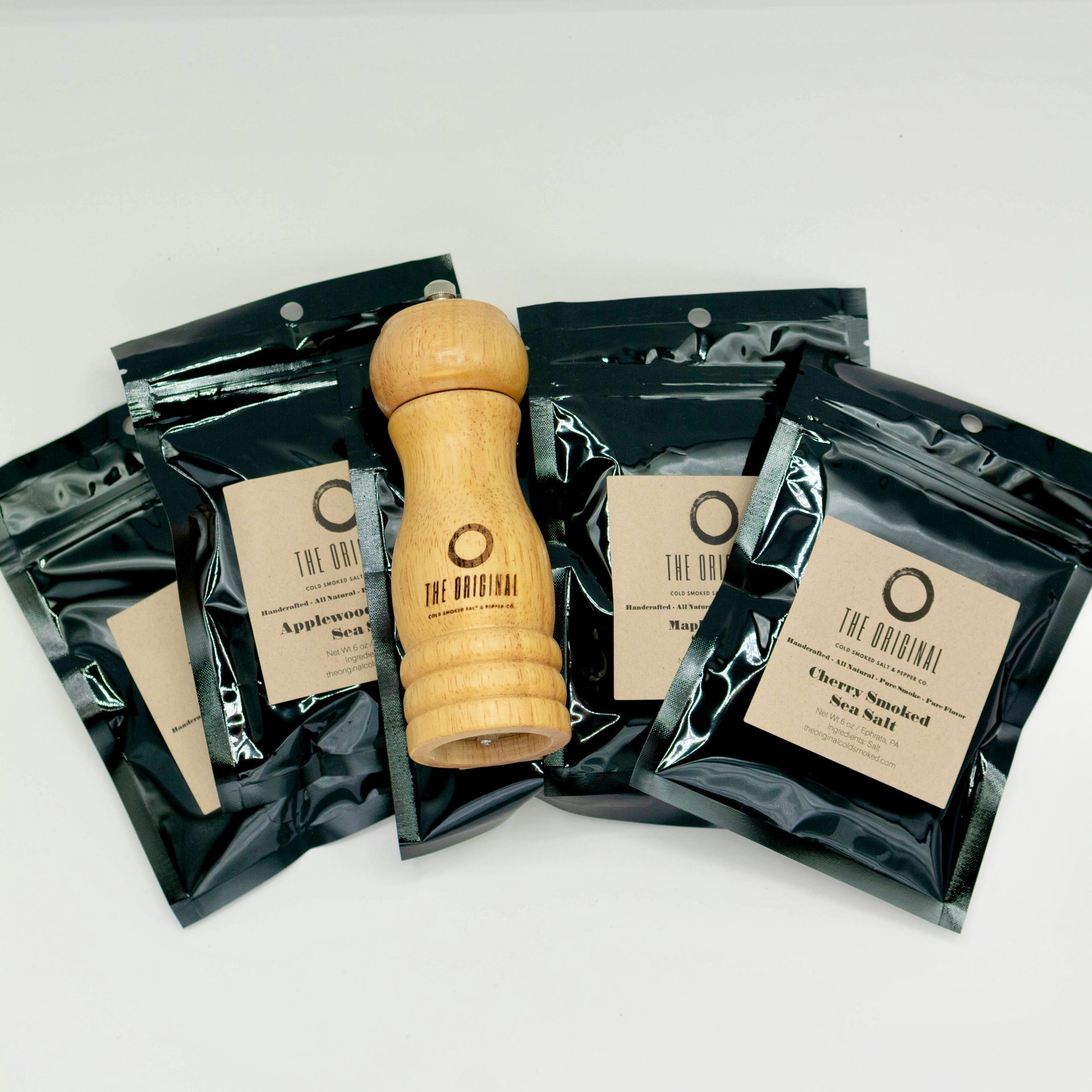 A cardboard box filled with spices and a salt shaker that says the original