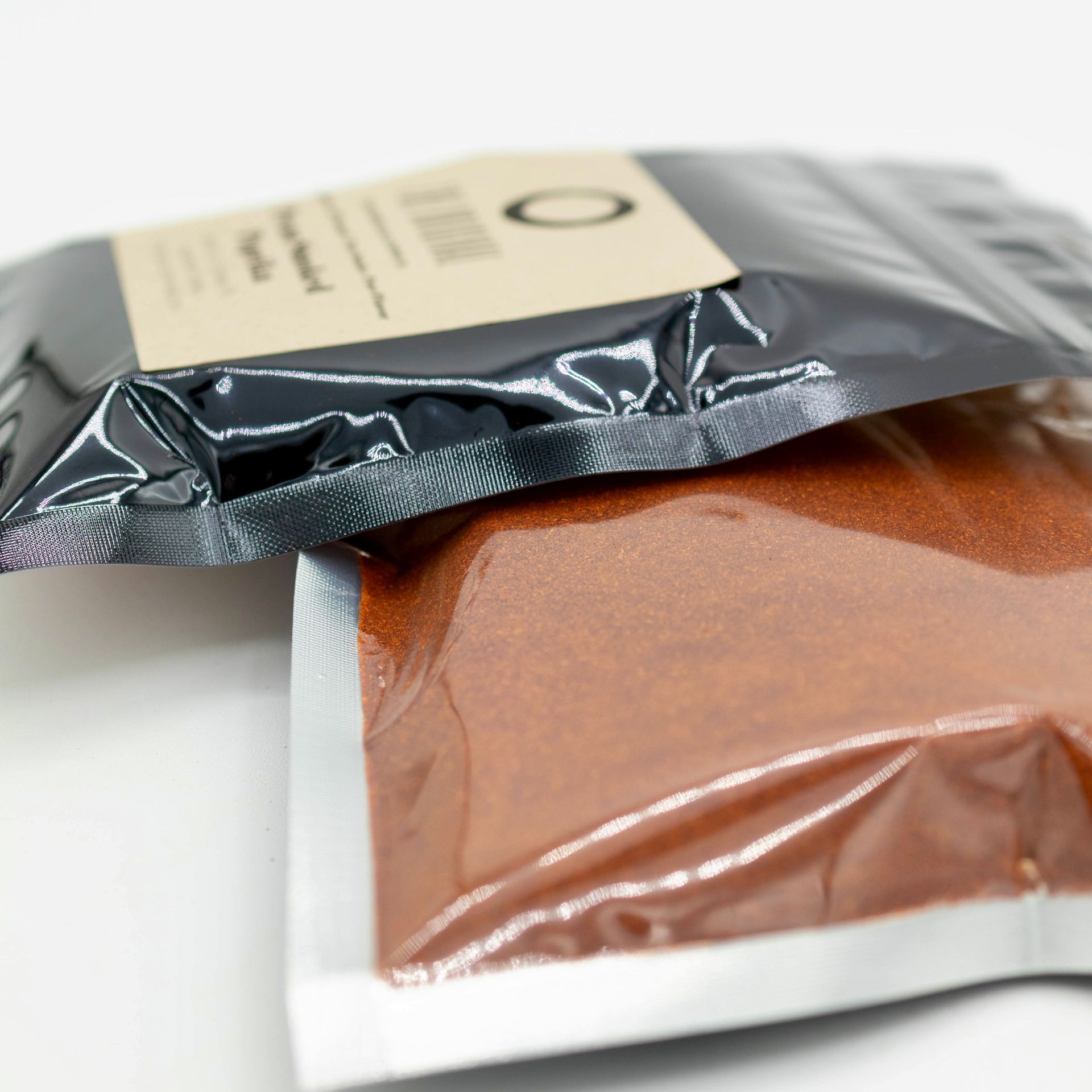 A bag of pecan smoked paprika next to a glass of wood chips