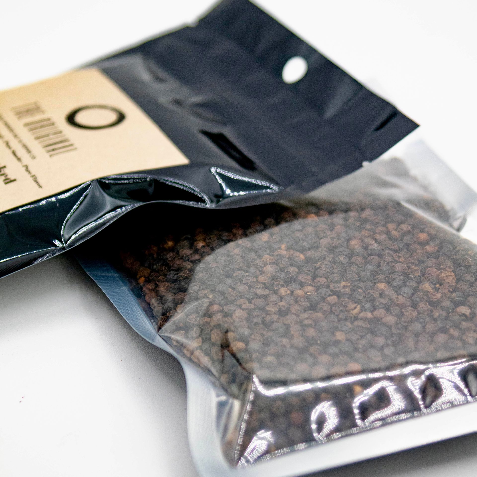 A bag of smoked peppermint next to a glass of wood chips