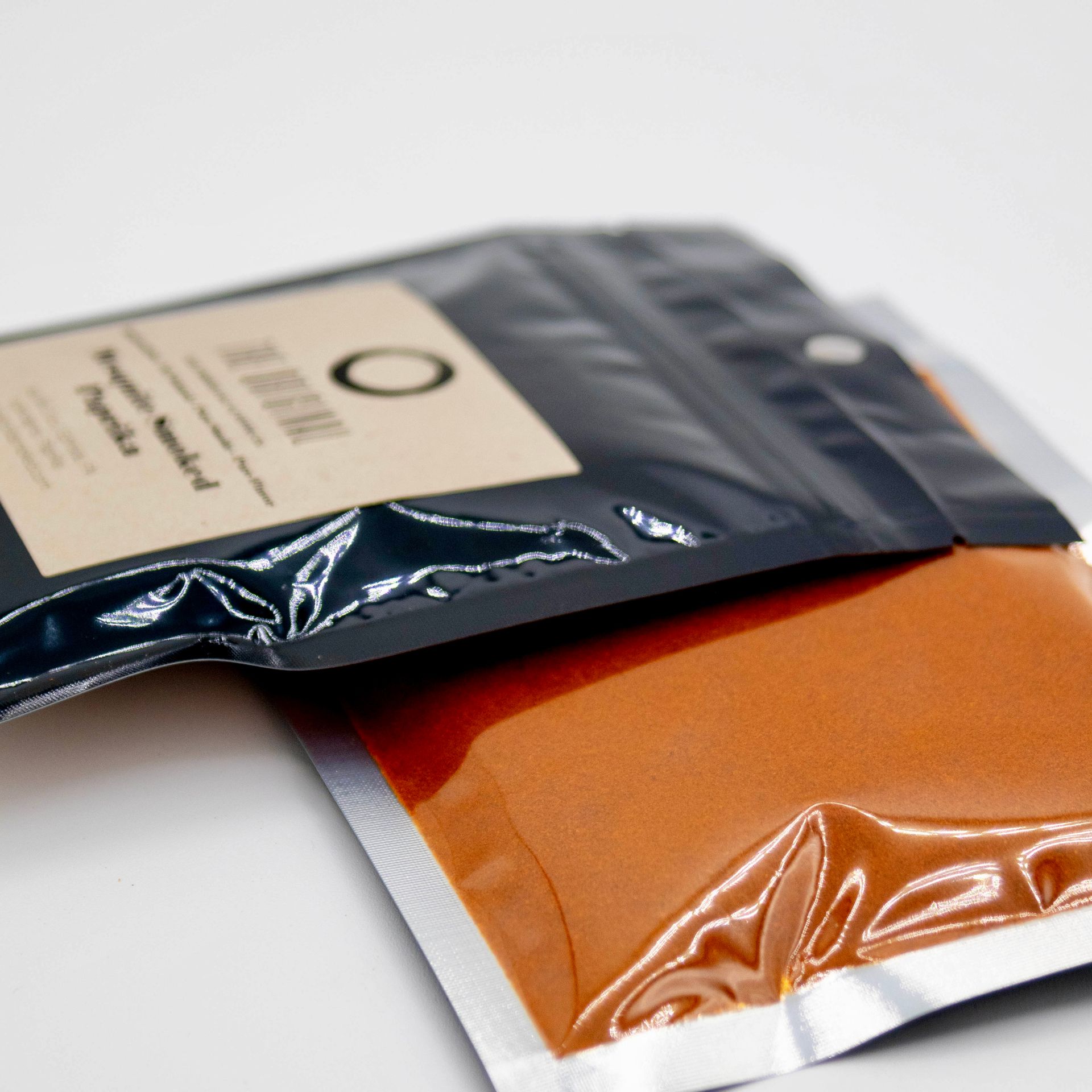 A bag of mosquito roasted paprika next to a glass of mosquito roasted paprika