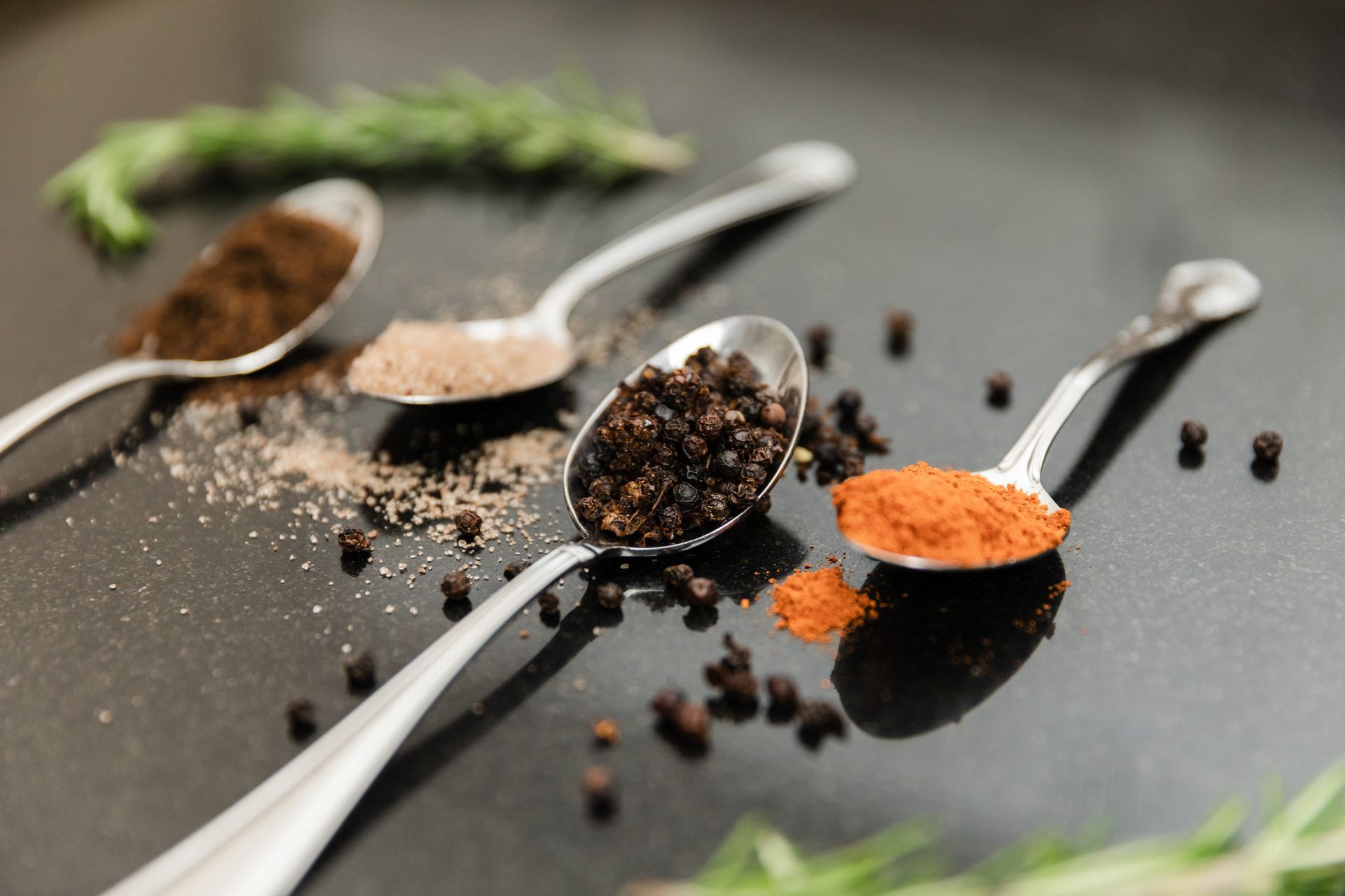 There are many different types of spices in the spoons.
