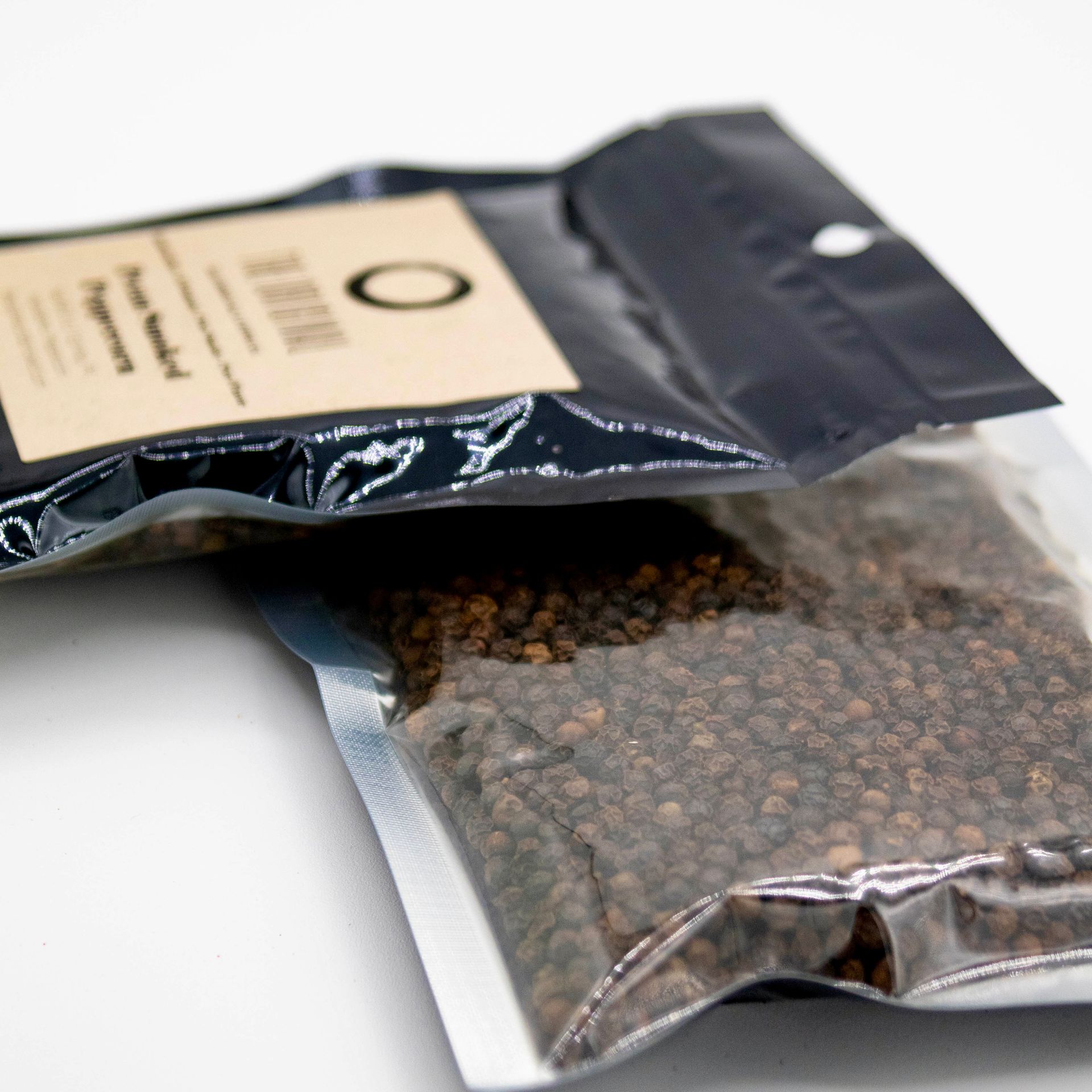 A bag of the original peppercorns sits next to a glass of wood chips