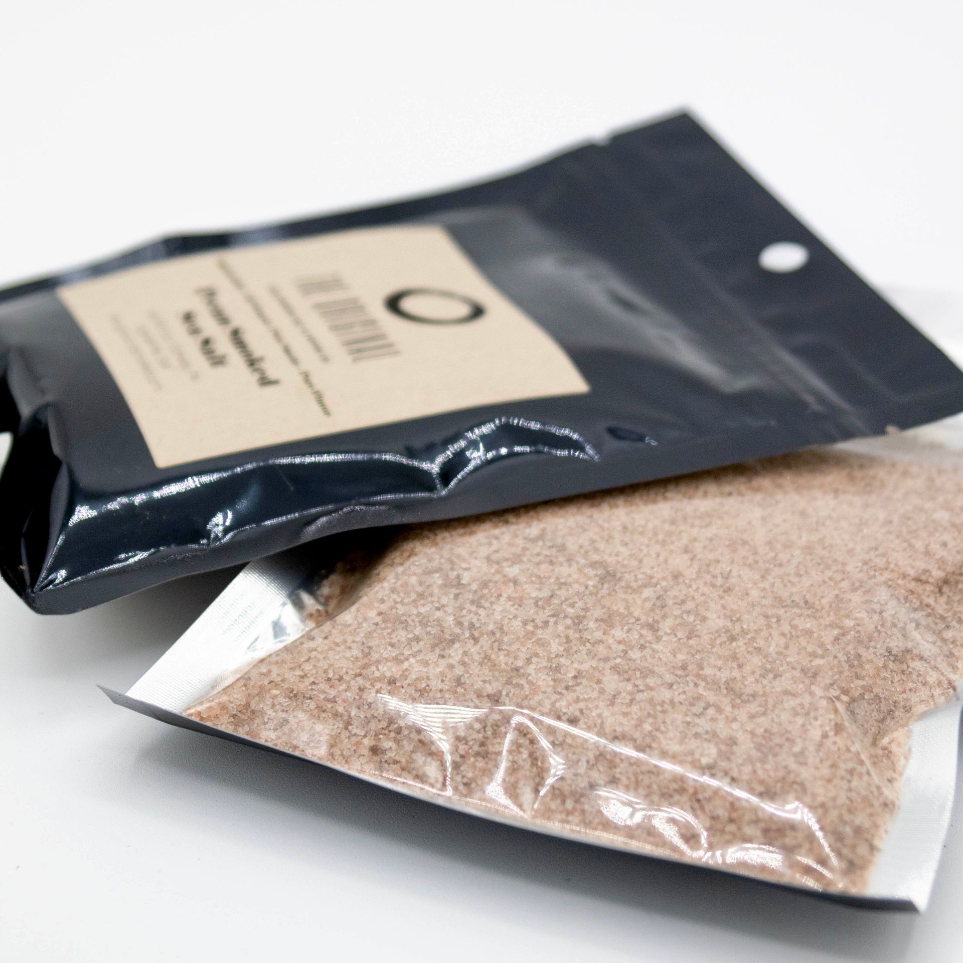 Two bags of brown powder are stacked on top of each other