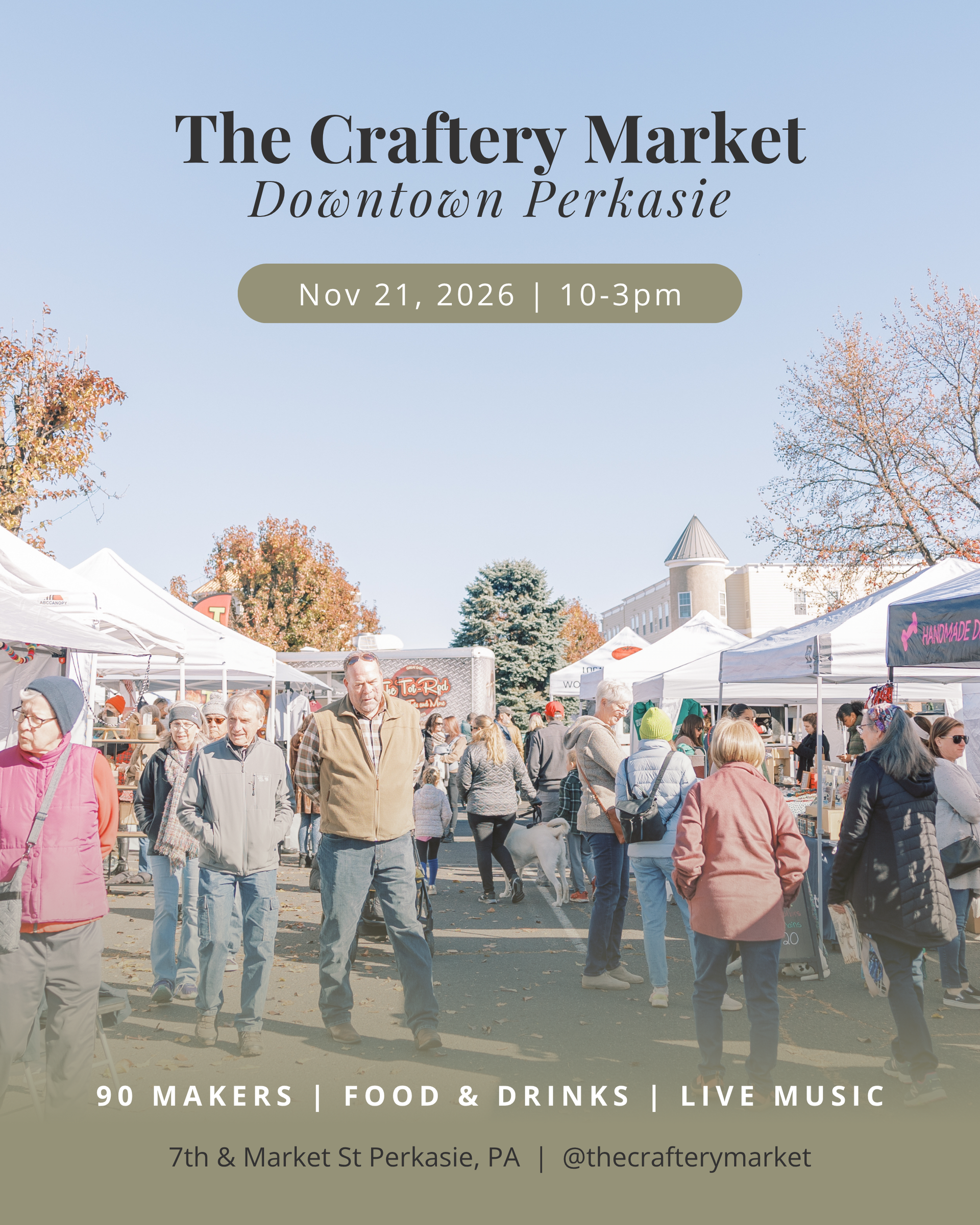 Crowded outdoor craft market under blue sky with white tents, vendors, and visitors walking among booths