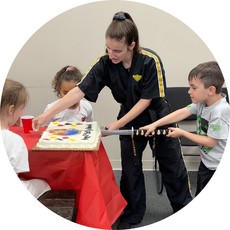 A group of children are blowing out candles on a birthday cake.