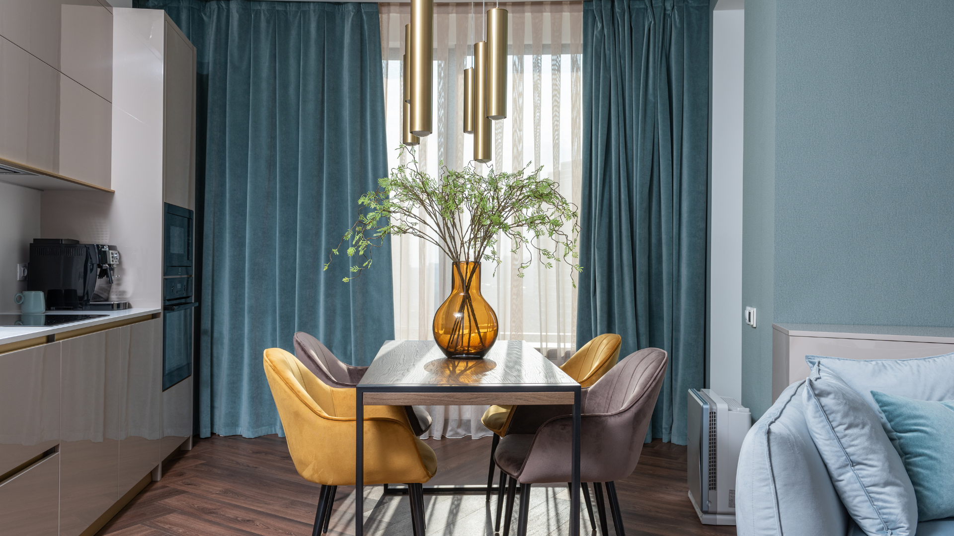 A dining room with a table and chairs and a vase of flowers on it.