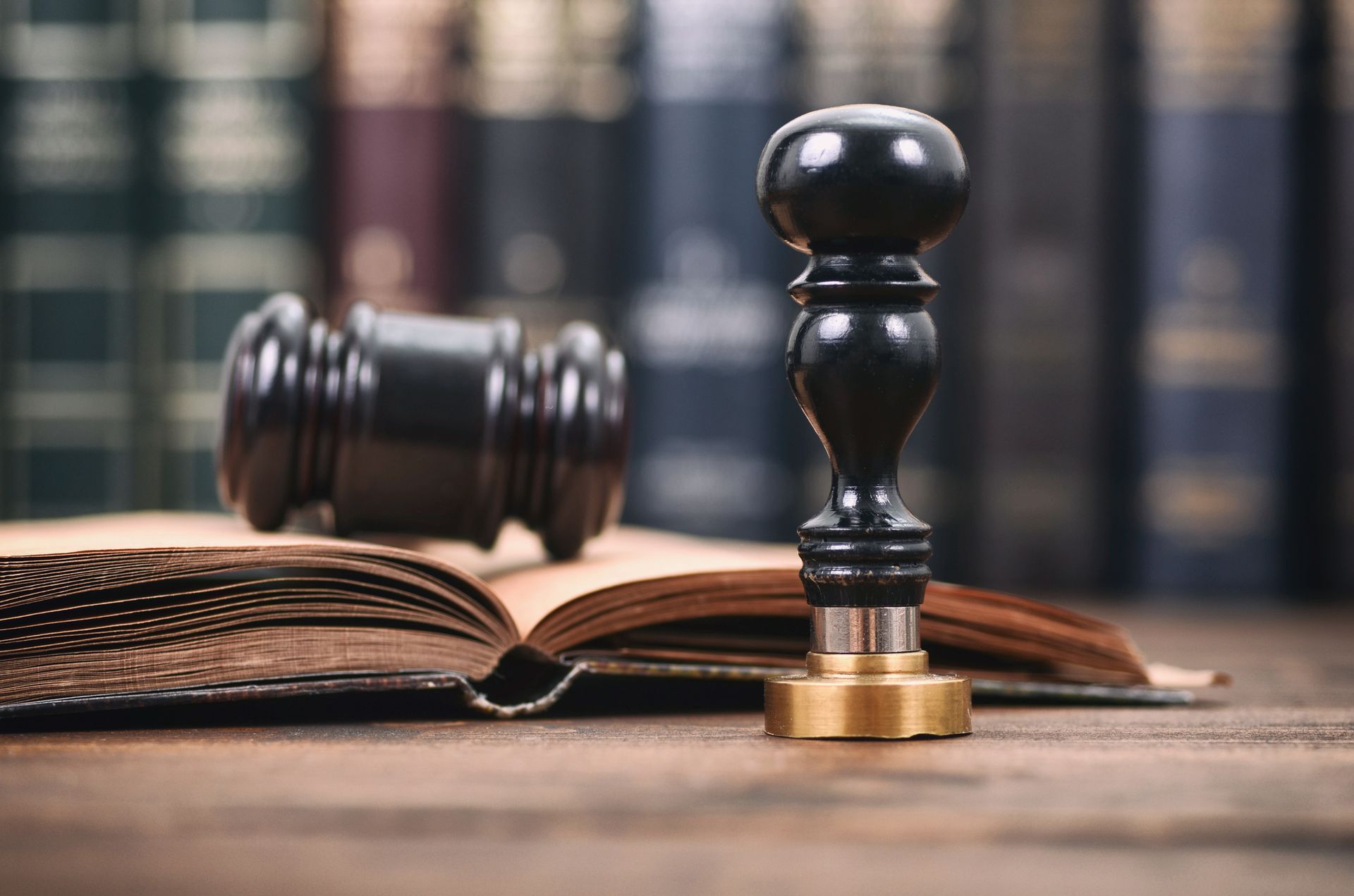 Wooden background with notary seal and gavel representing probate attorney estate legal support.