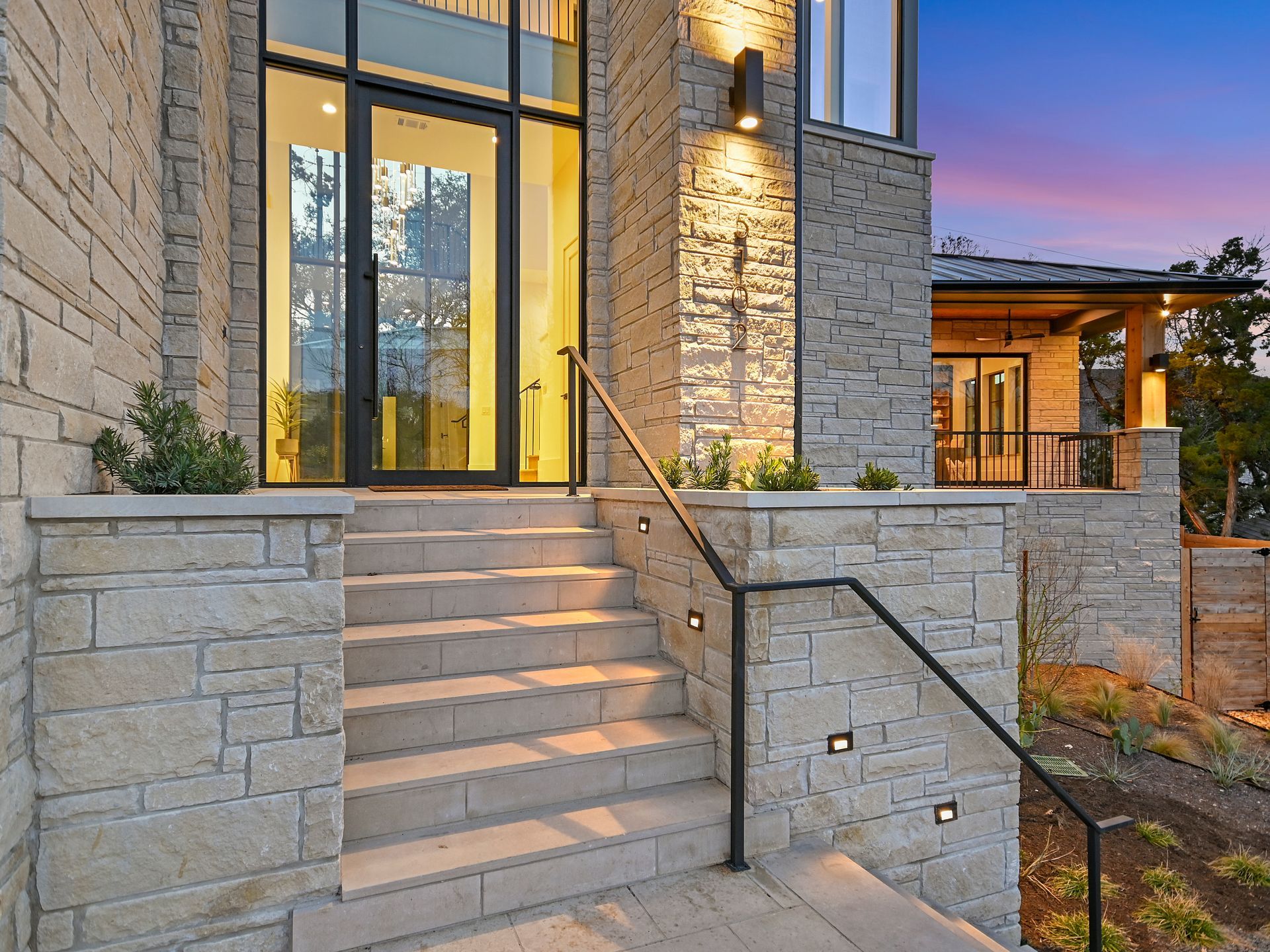 A set of stairs leading up to the front door of a house.