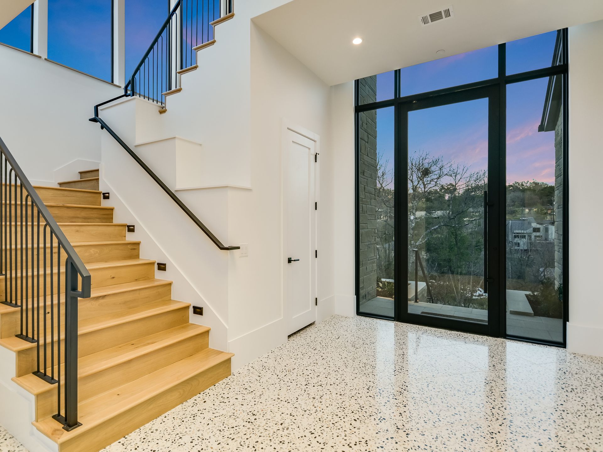 A staircase in a house with a large window