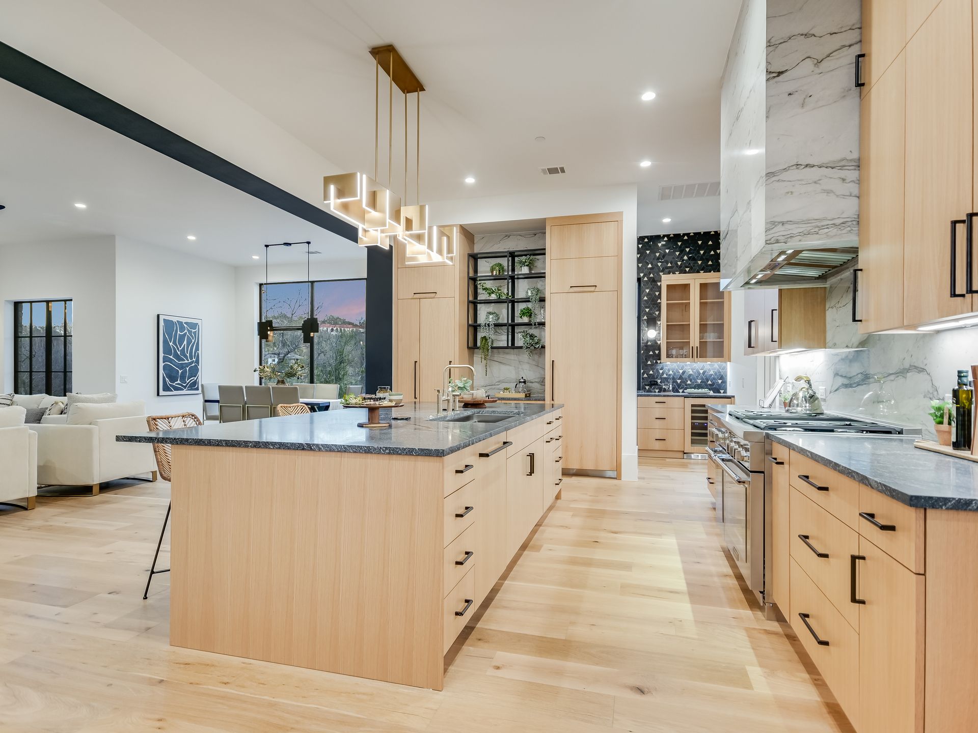 A kitchen with wooden cabinets , granite counter tops , and stainless steel appliances.