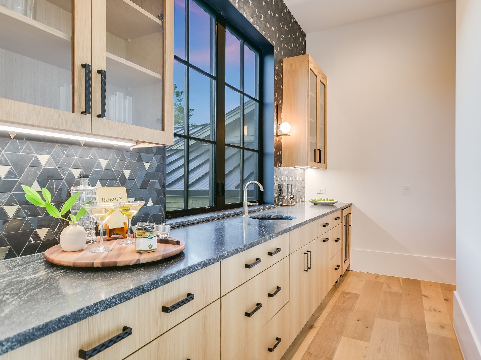 A kitchen with a lot of cabinets and a large window