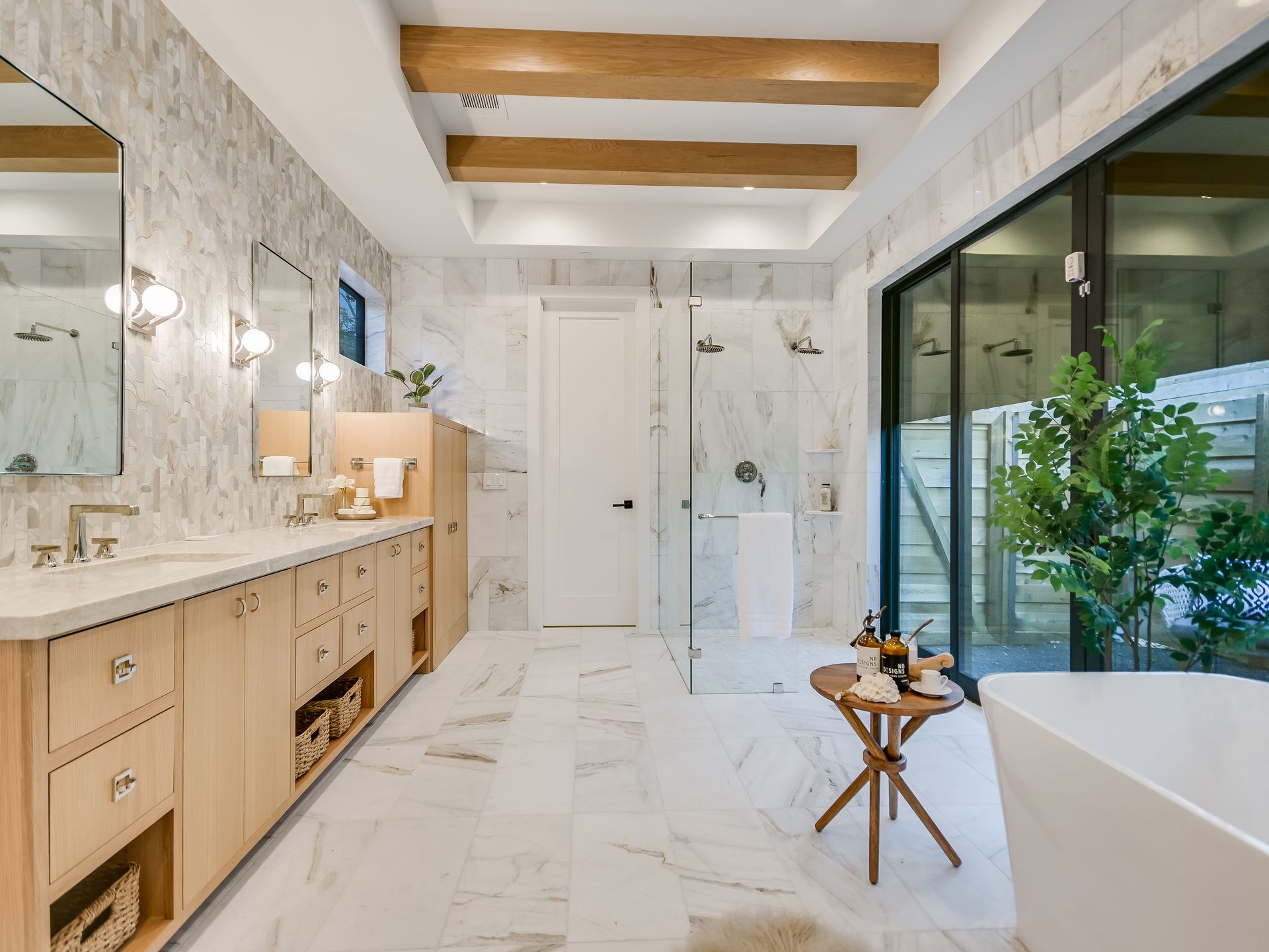 A bathroom with two sinks , a tub , and a walk in shower.
