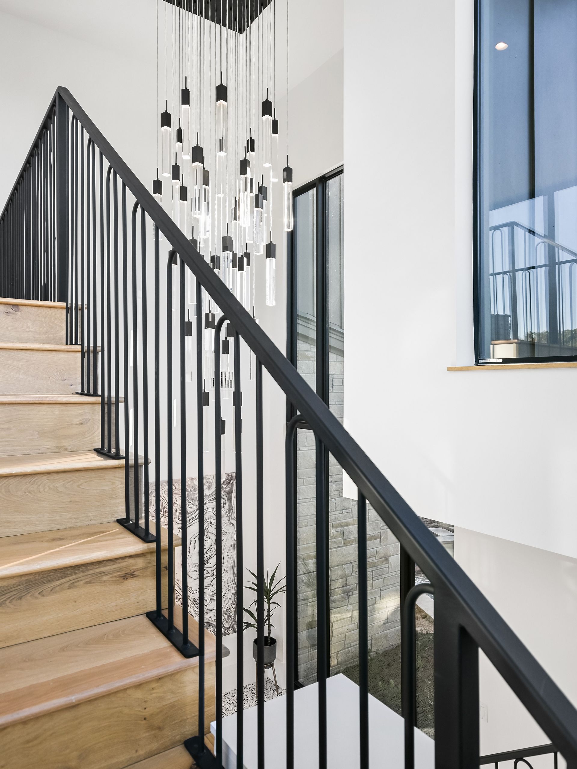 A staircase with a black railing and wooden steps