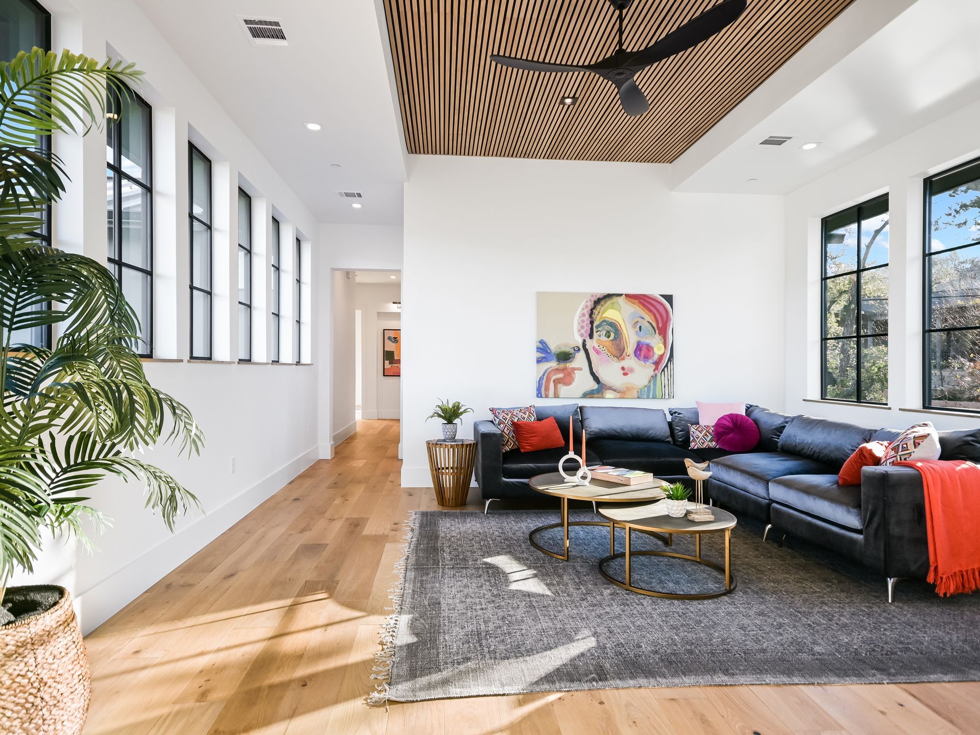 A living room filled with furniture and a ceiling fan.