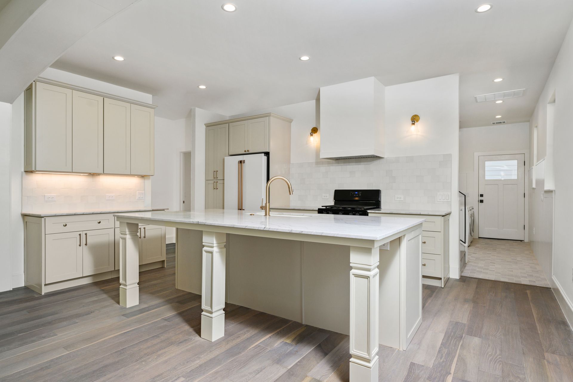 There is a large island in the middle of the kitchen.