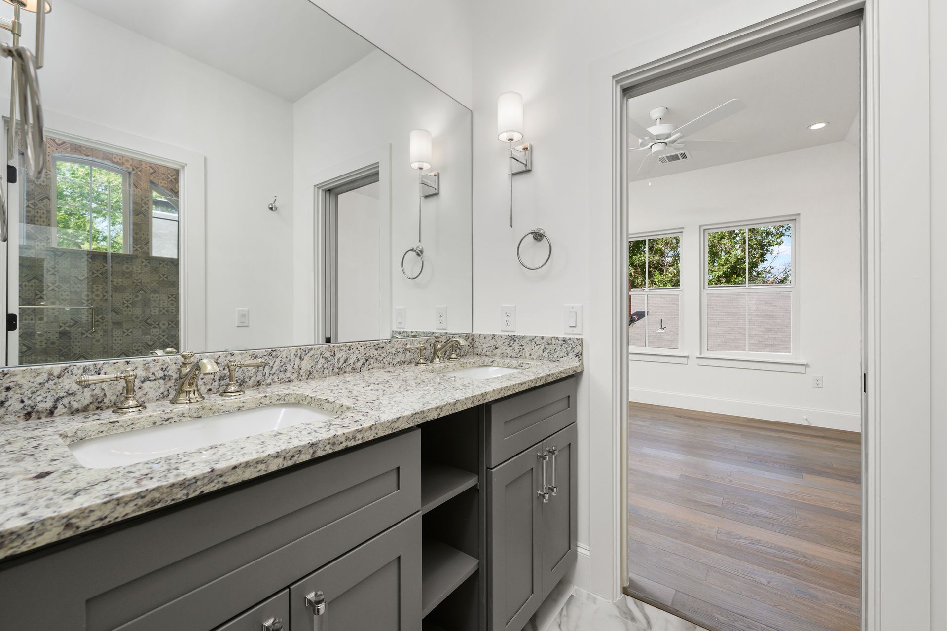 A bathroom with two sinks and a large mirror.