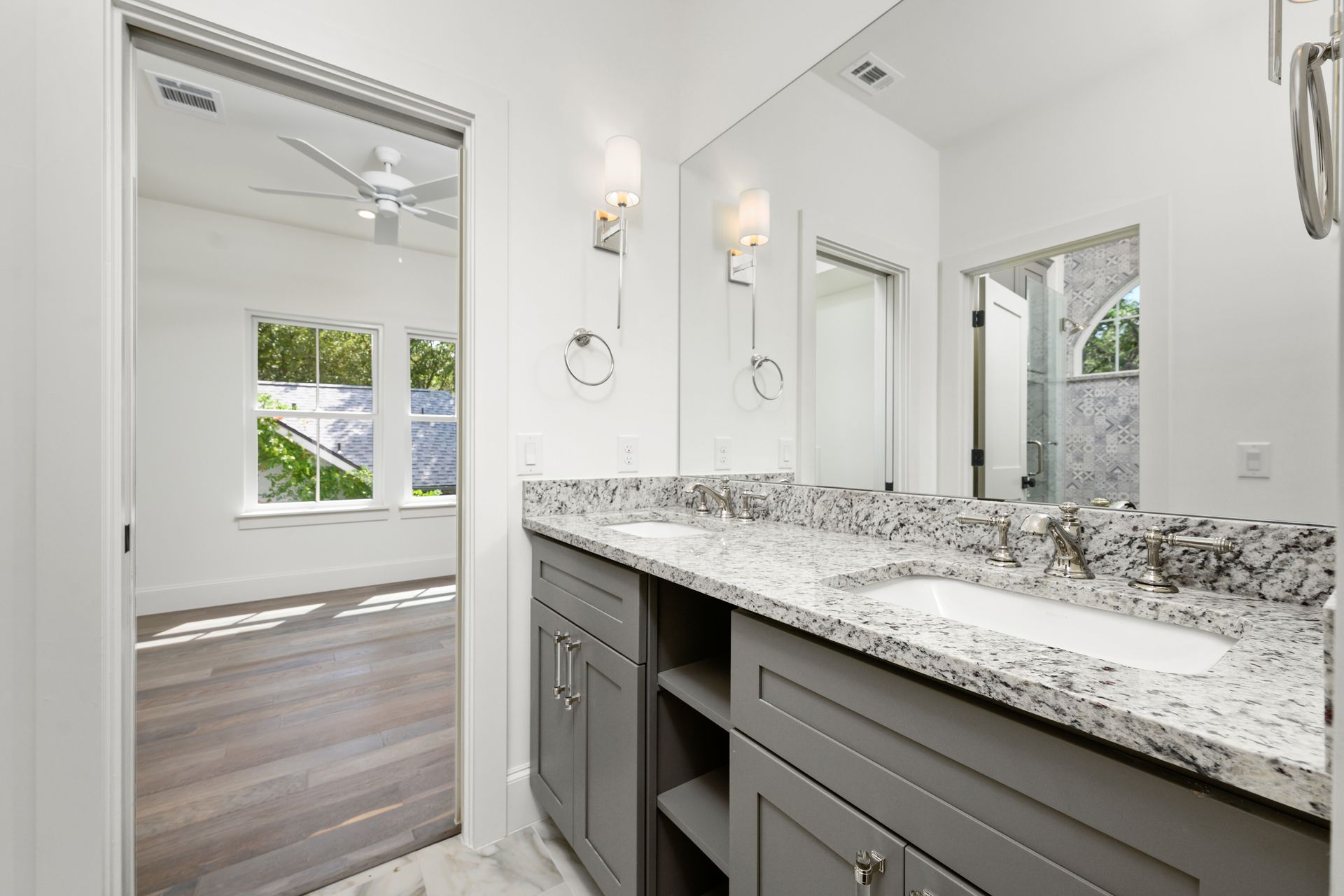 A bathroom with two sinks and a large mirror.