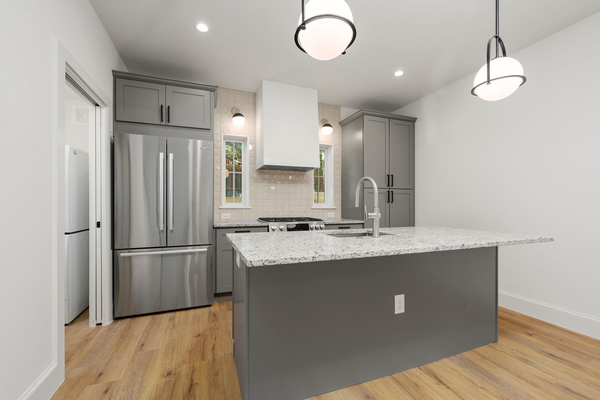 A kitchen with a large island and stainless steel appliances