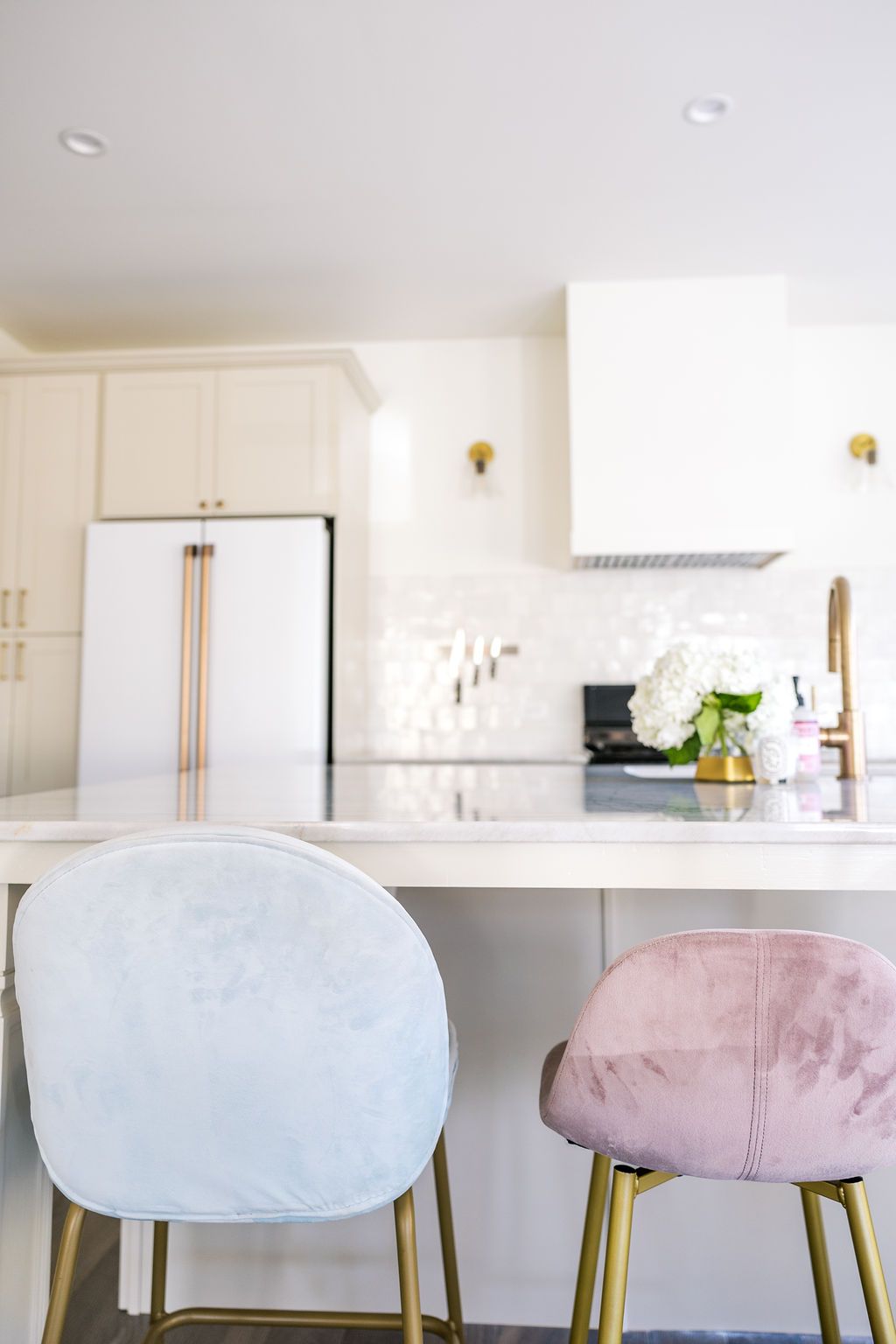 Two chairs are sitting at a table in a kitchen.