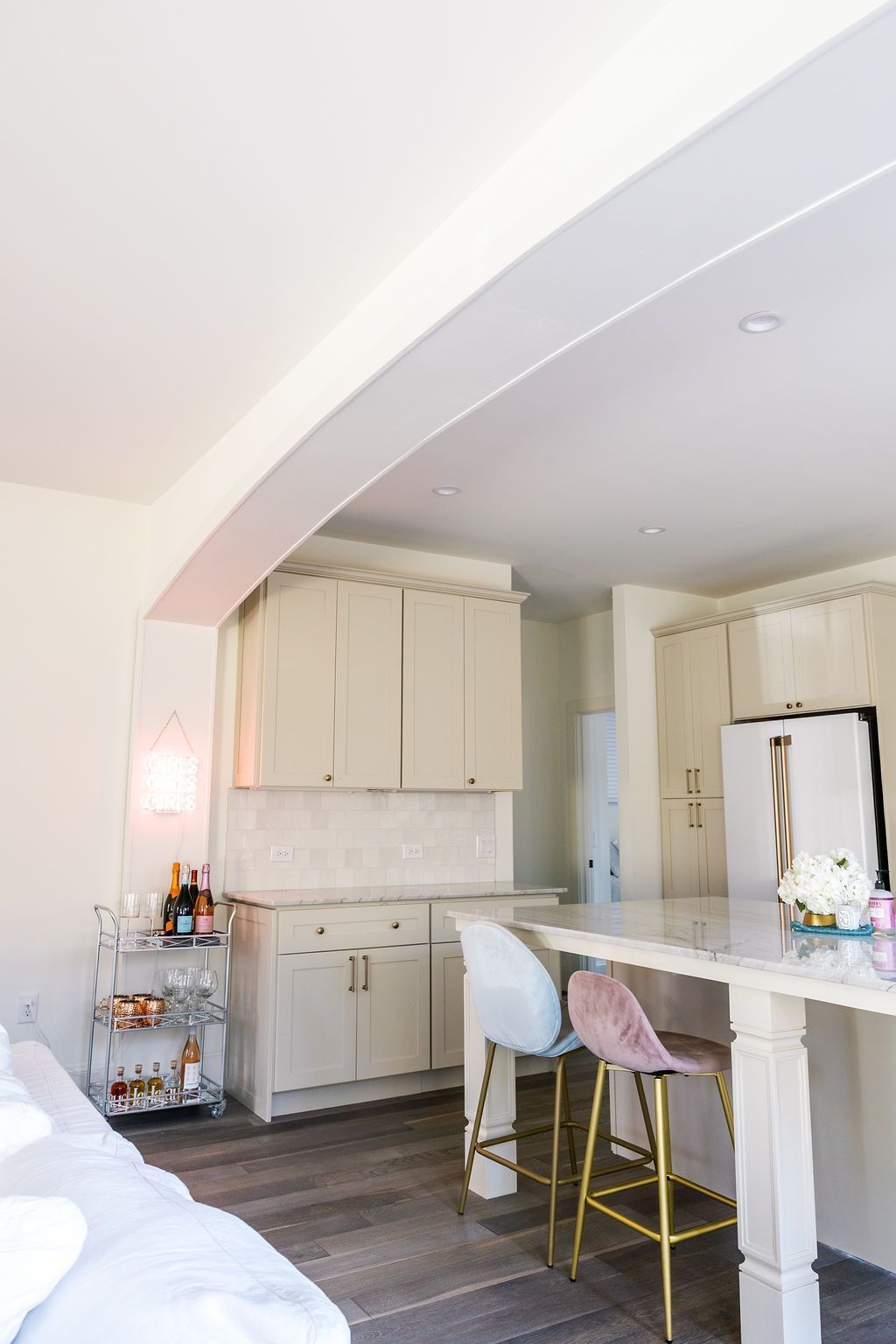 A kitchen with a table and chairs and a refrigerator.